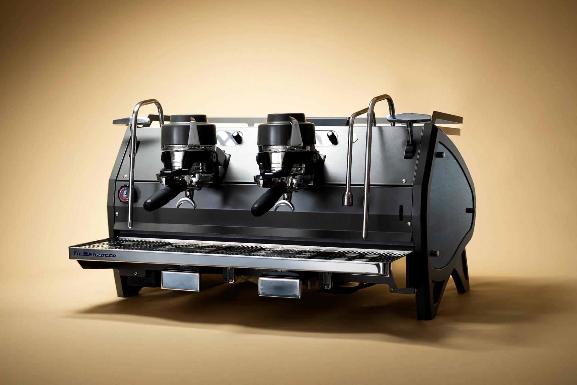 Espresso machine against a warm gradient background.