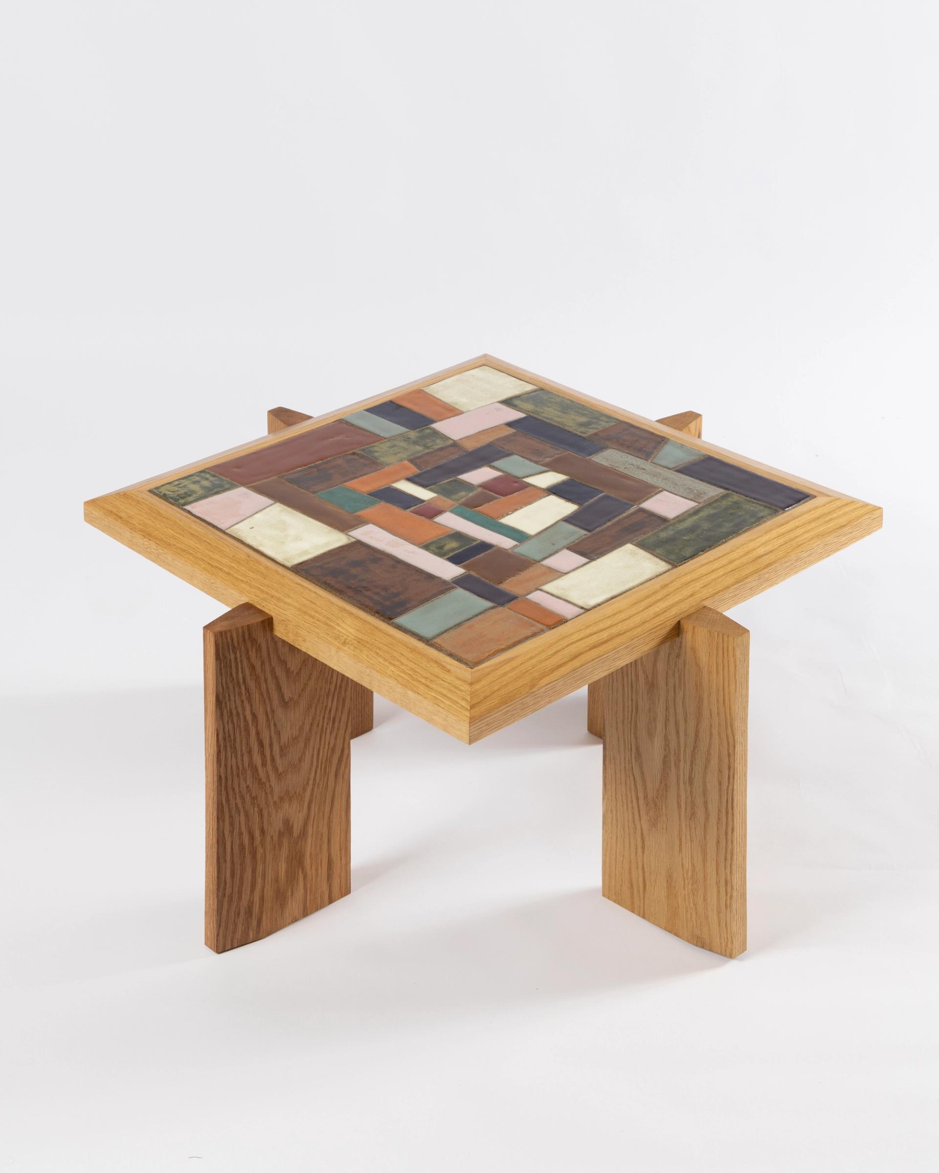 A wooden table with a colorful mosaic top.