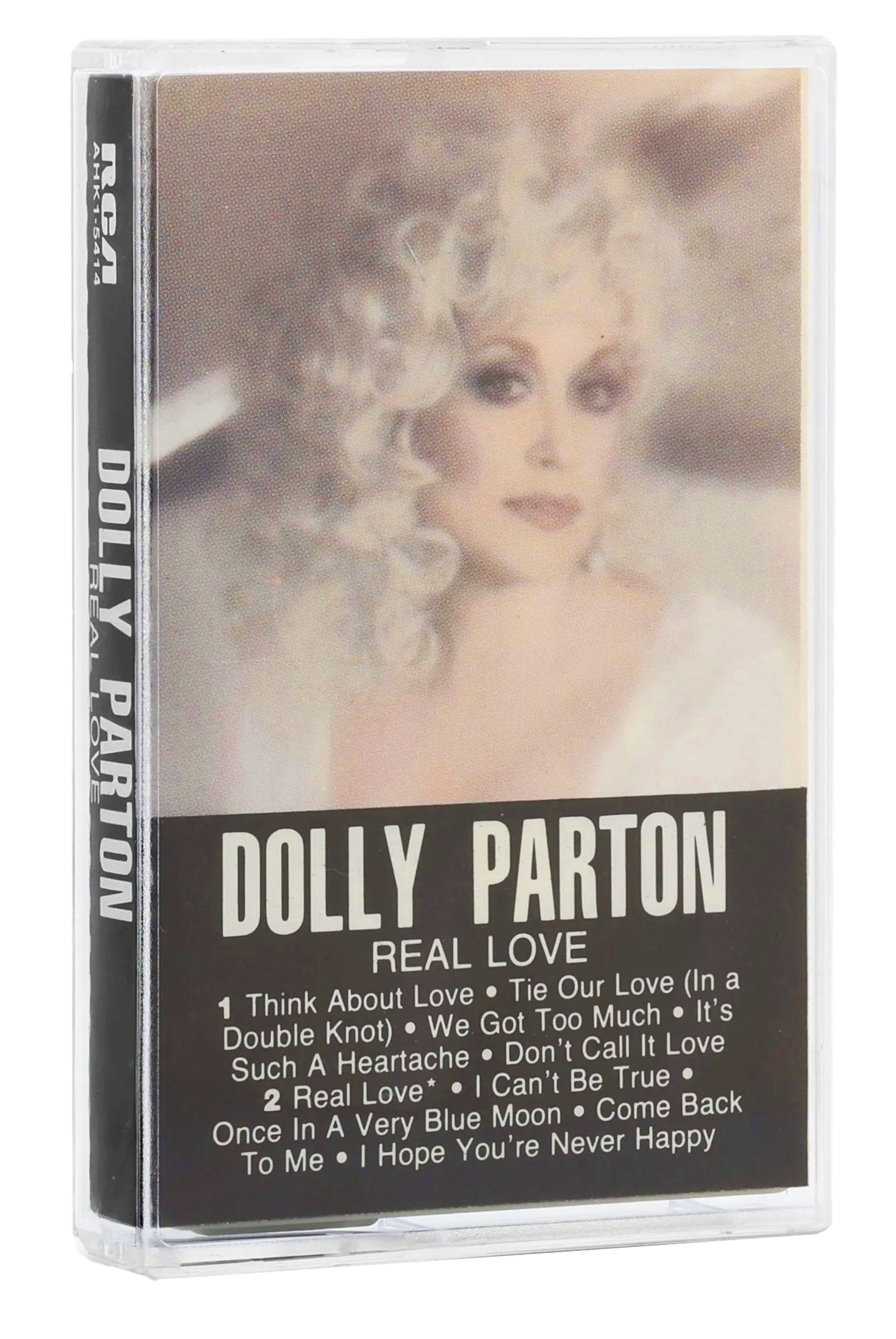 A cassette tape of Dolly Parton's Real Love on RCA, with a soft-focus portrait on the cover and a track listing printed on the lower half of the case