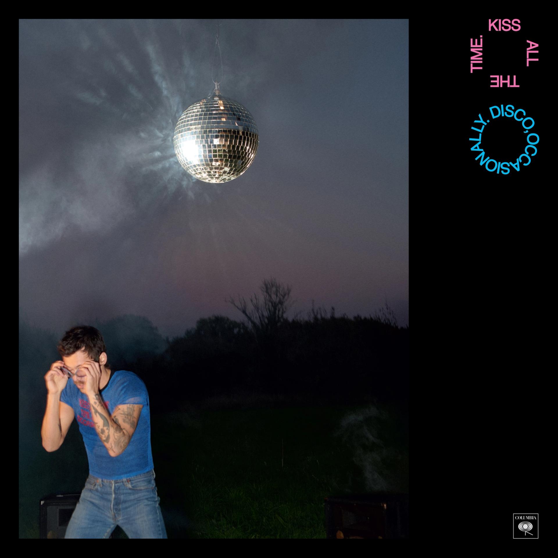 Album cover: a man in a blue shirt and jeans at the bottom left corner of the image stand beneath a disco ball.