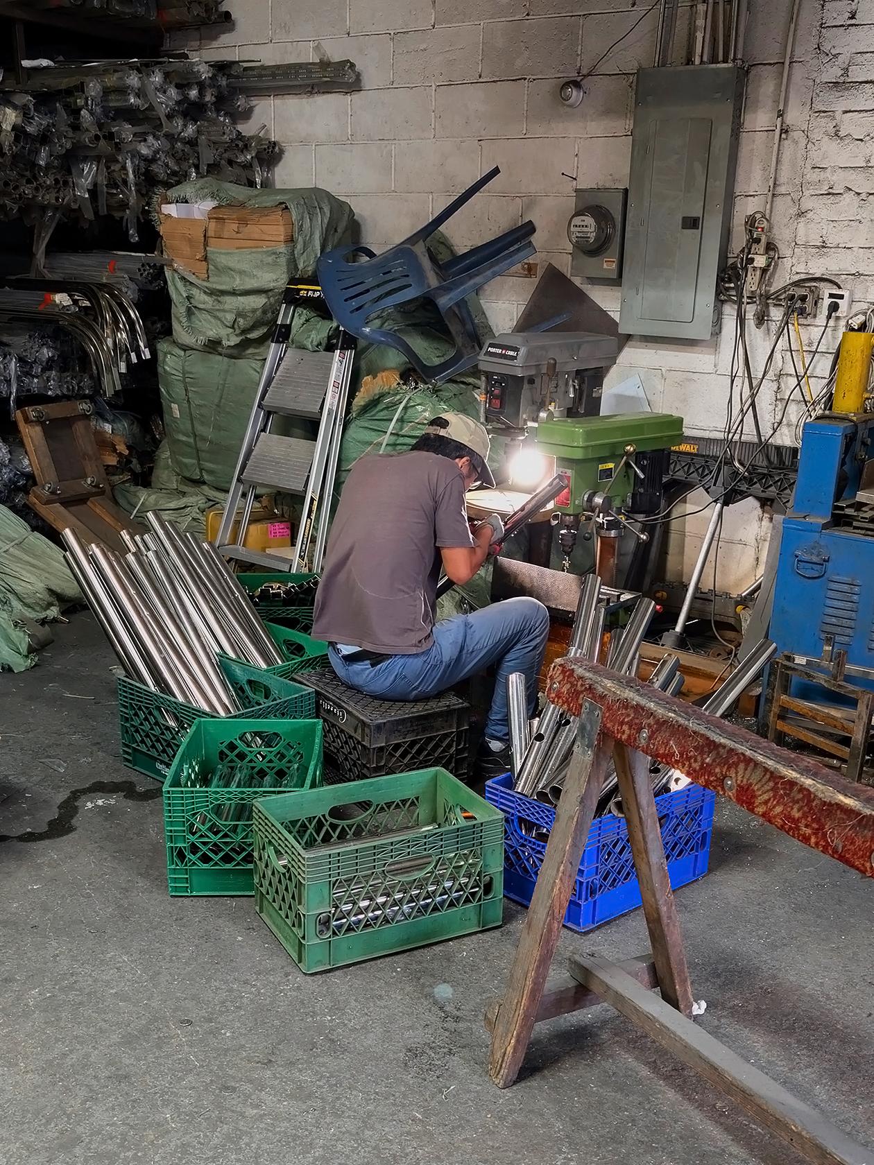 A metalworker prepares materials in the Brooklyn Stainless Steel workshop.