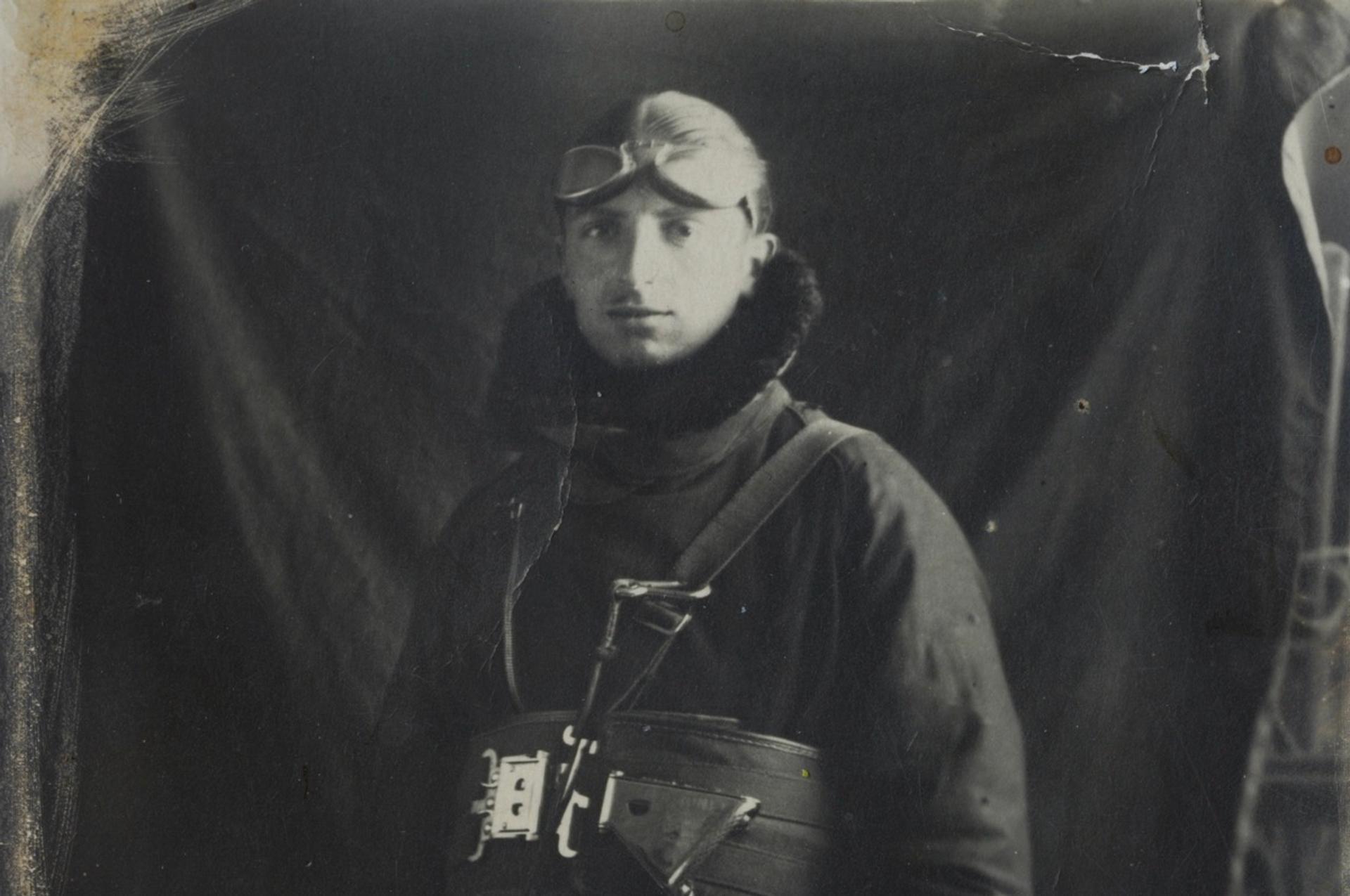 Black-and-white photo of a man in a flight helmet