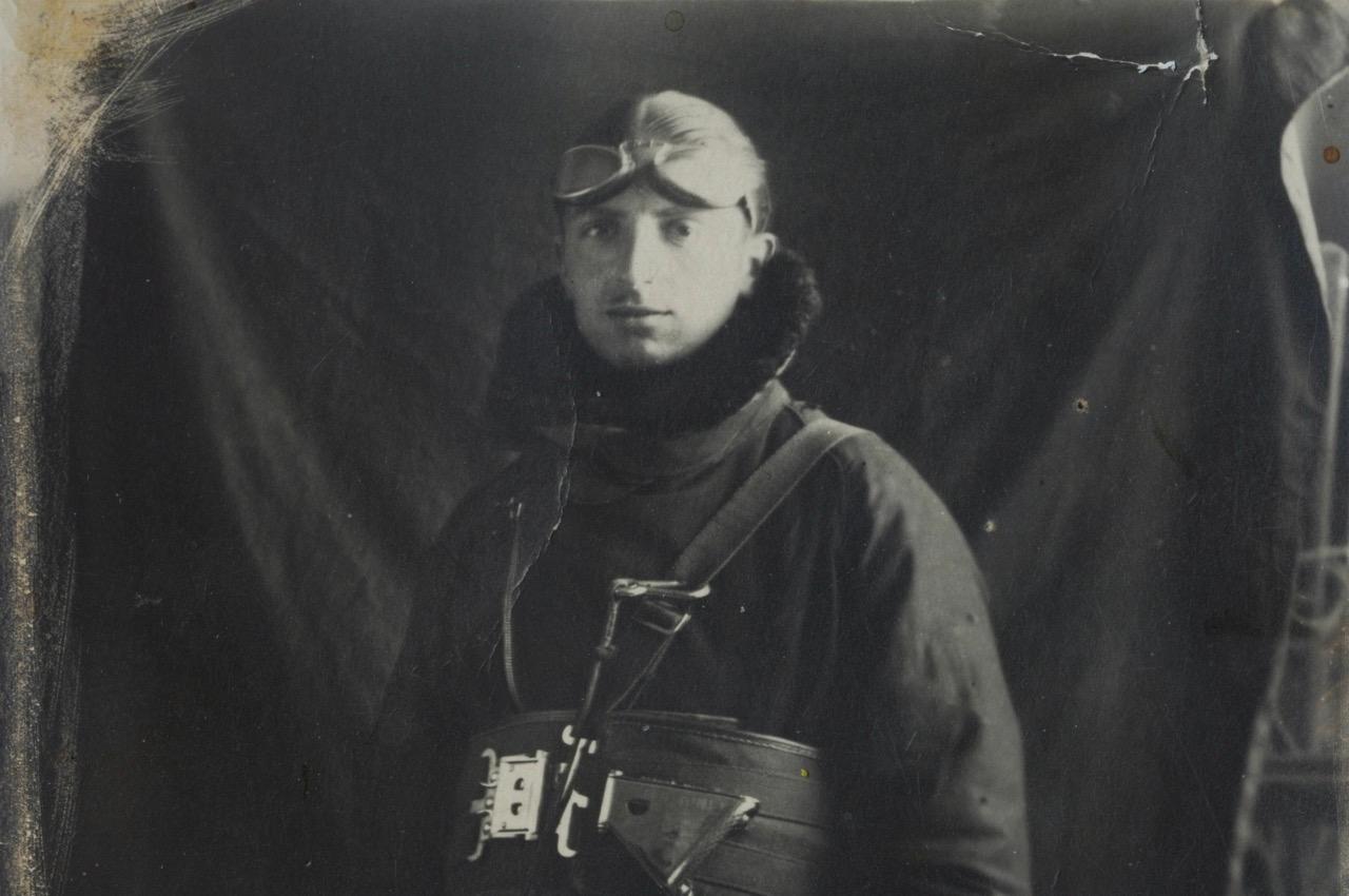 Black-and-white photo of a man in a flight helmet