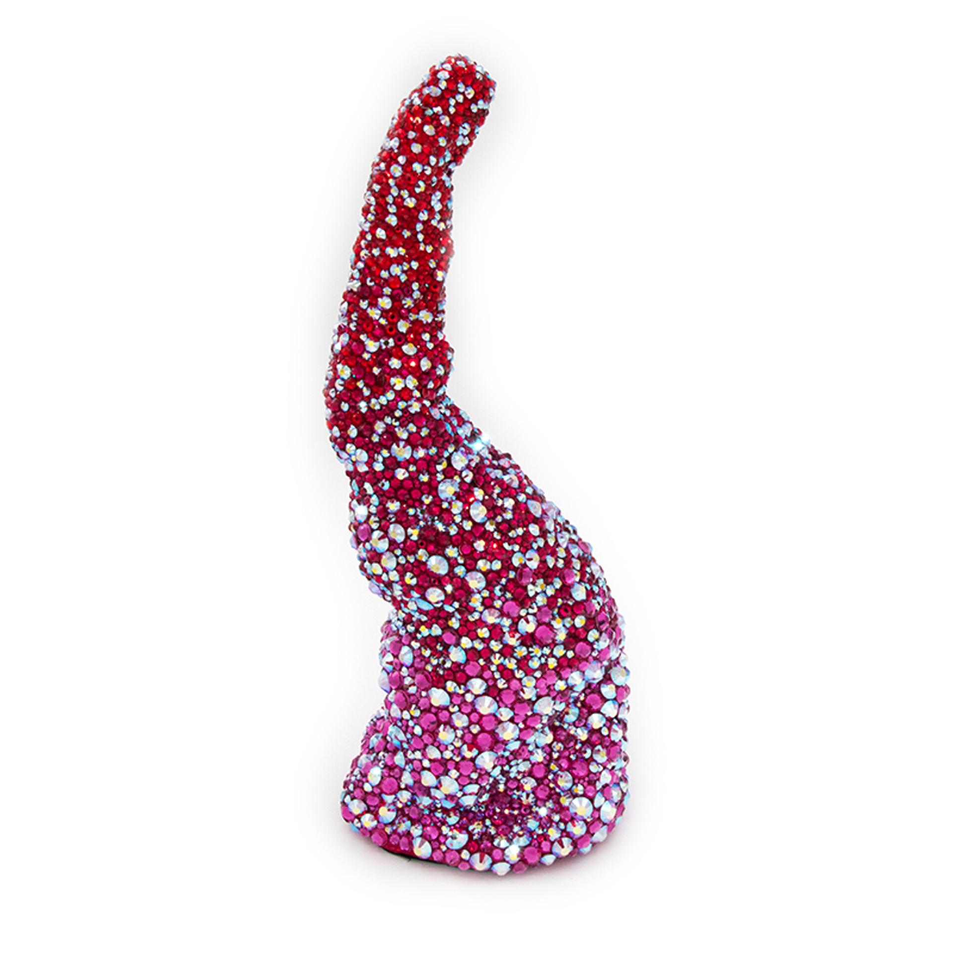 Abstract horn-shaped sculpture covered in red and pink crystals against white background.