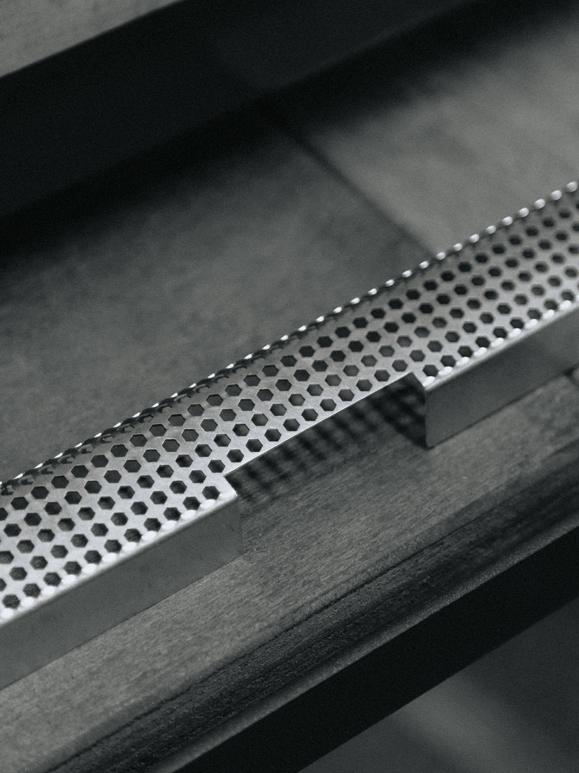 Cose-up photo of an espresso machine grate.