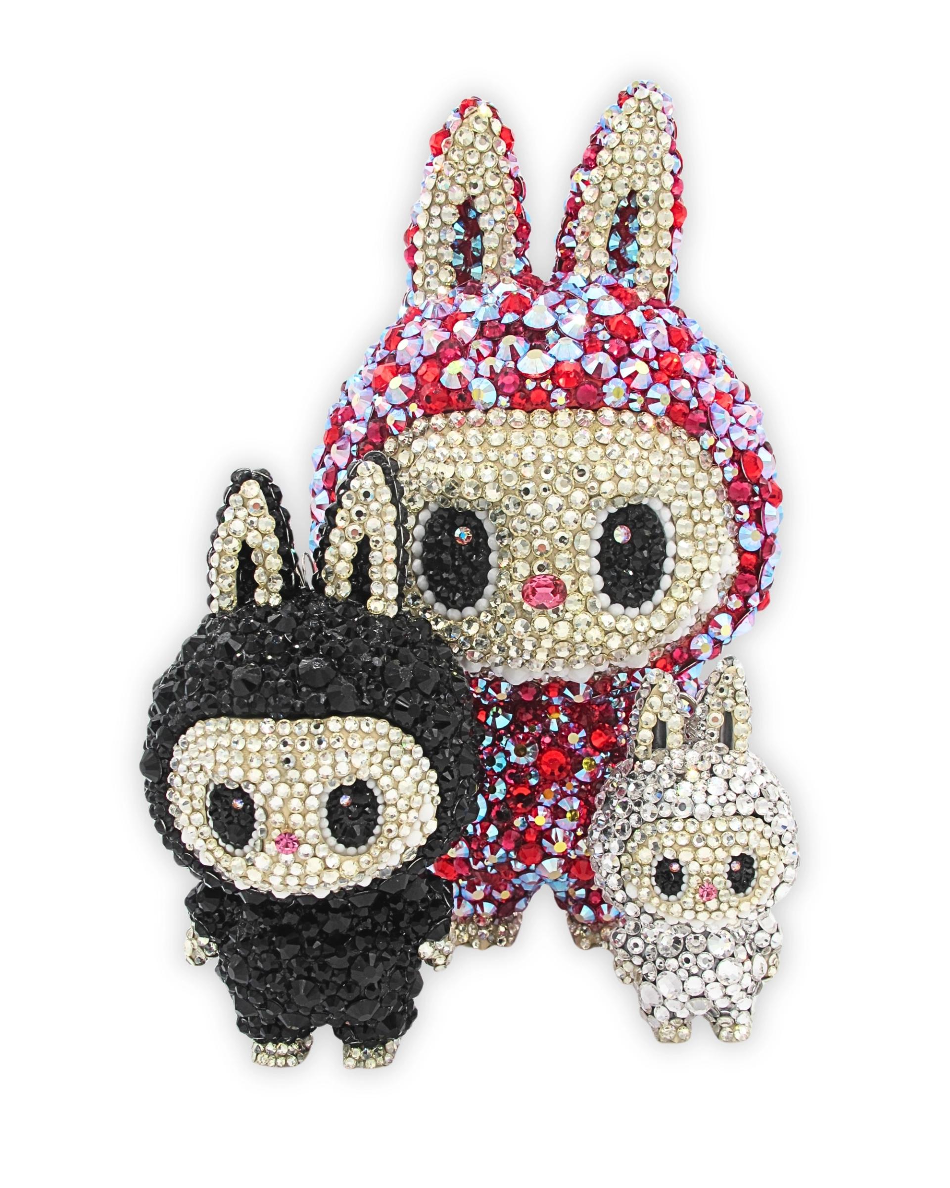 Crystal-covered cartoon rabbit figures in red, black, and white arranged against plain background.
