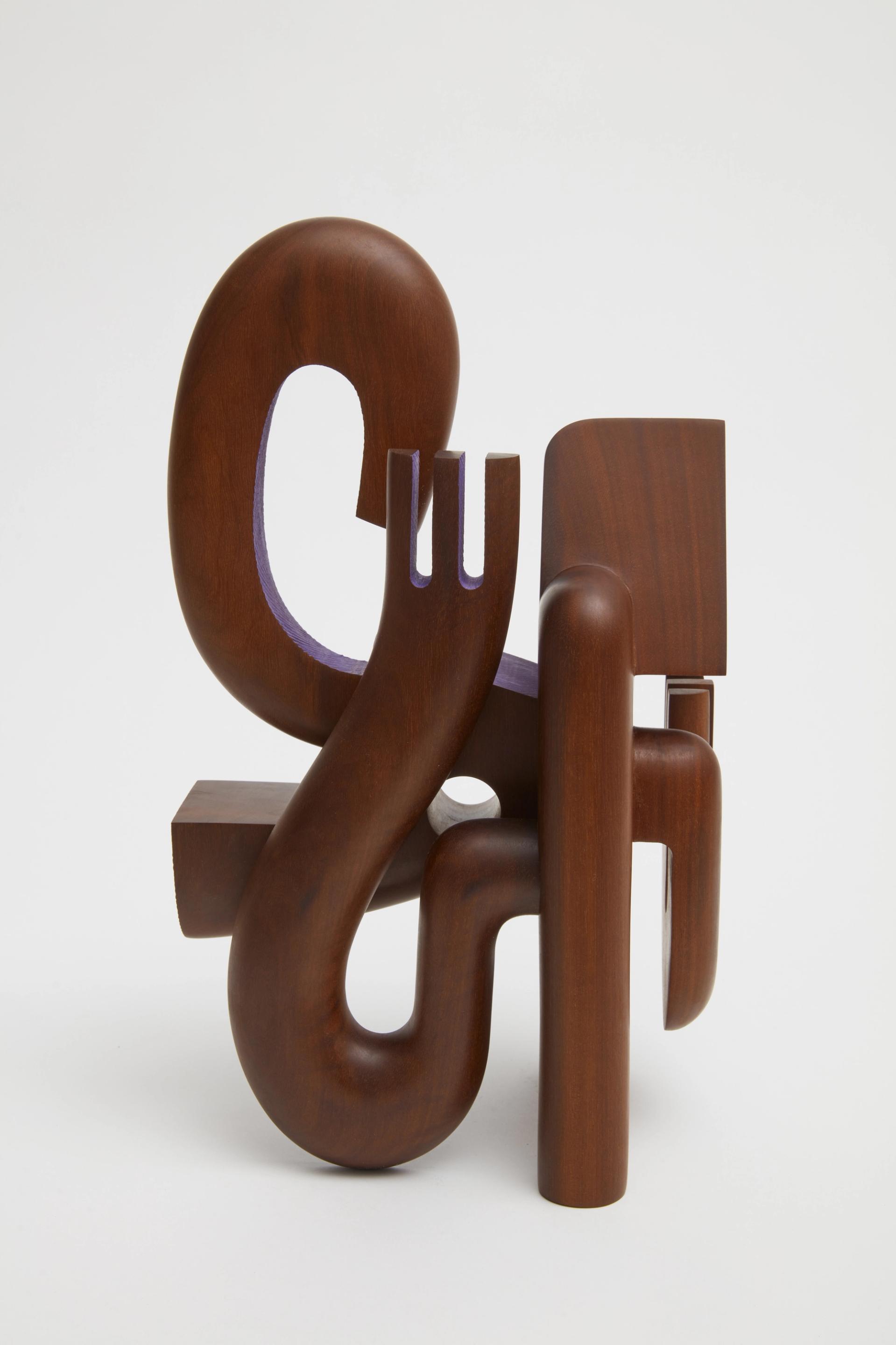 Abstract geometric hardwood sculpture with interlocking rounded and angular forms against a white background.
