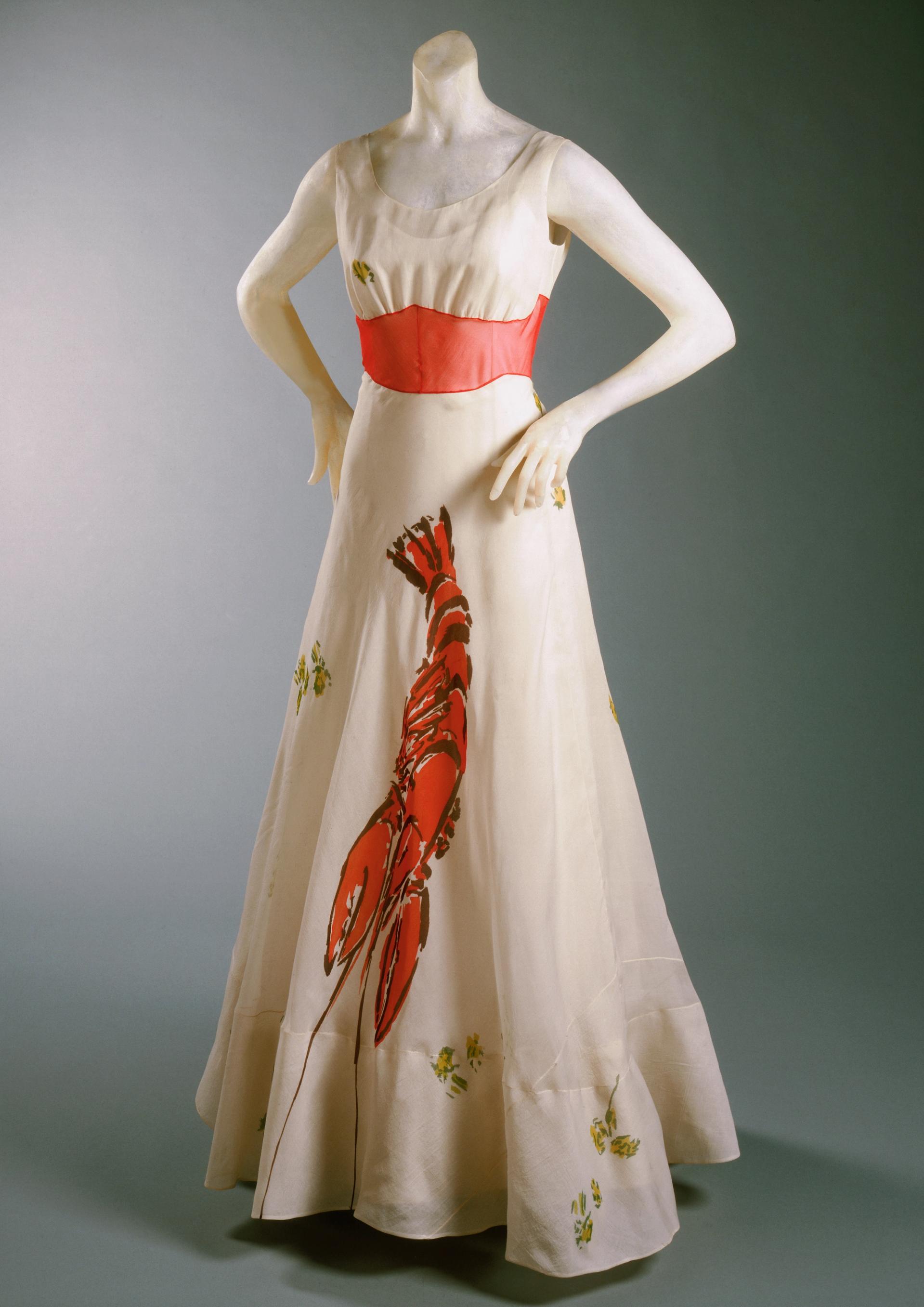 Schiaparelli white-and-orange lobster-print gown on a mannequin.