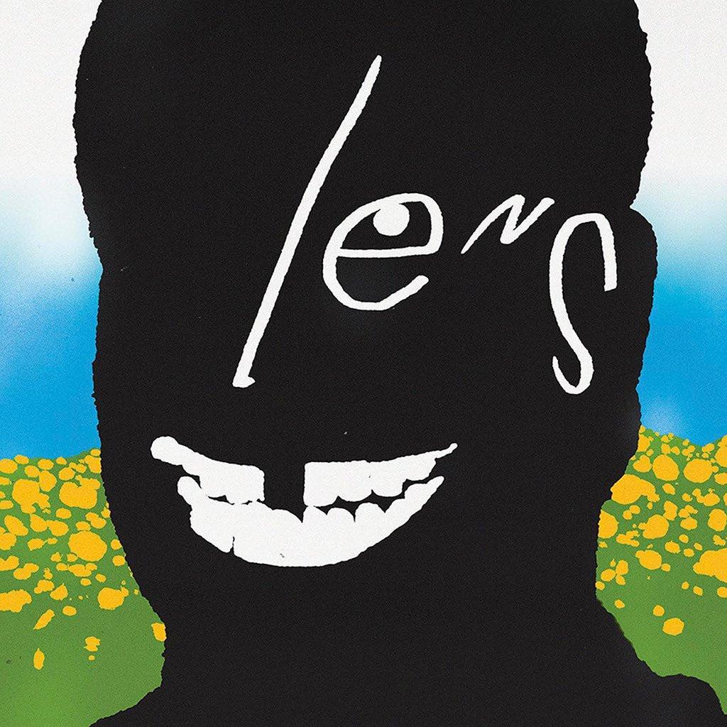 Black silhouette of a head against a bright, stylized background with blue sky and yellow-green ground. White text across the face reads “lens,” with a wide, cartoon-like white smile below.