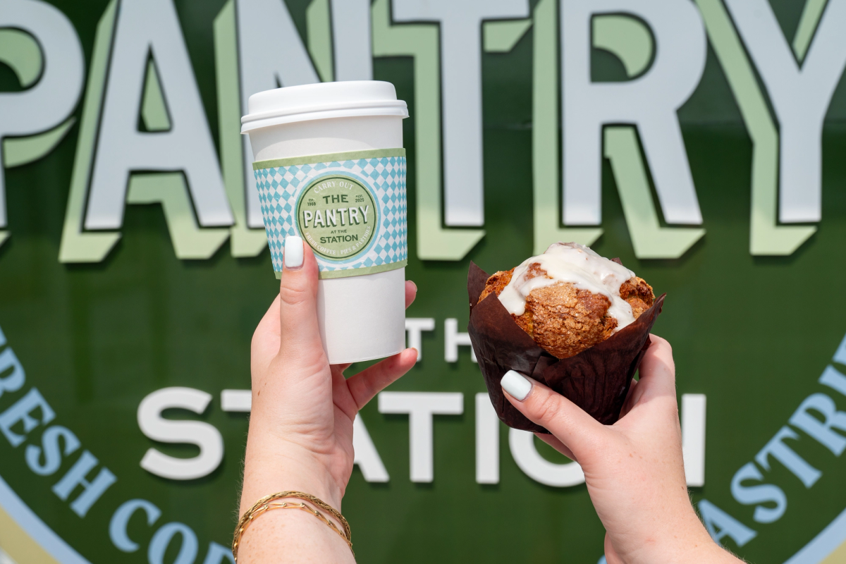 The Pantry cafe sign and coffee sleeve