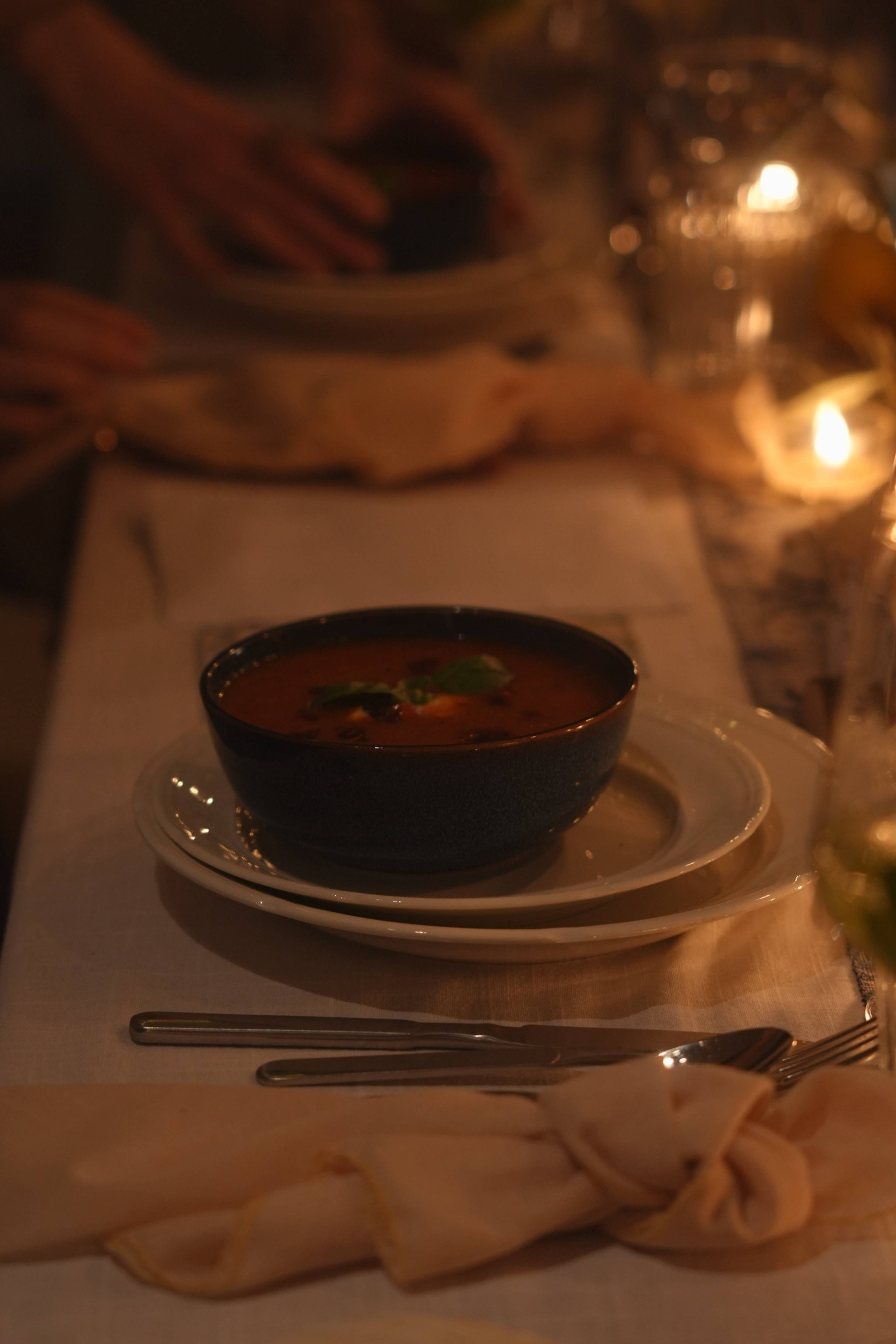 Bowl of tomato soup garnished with basil