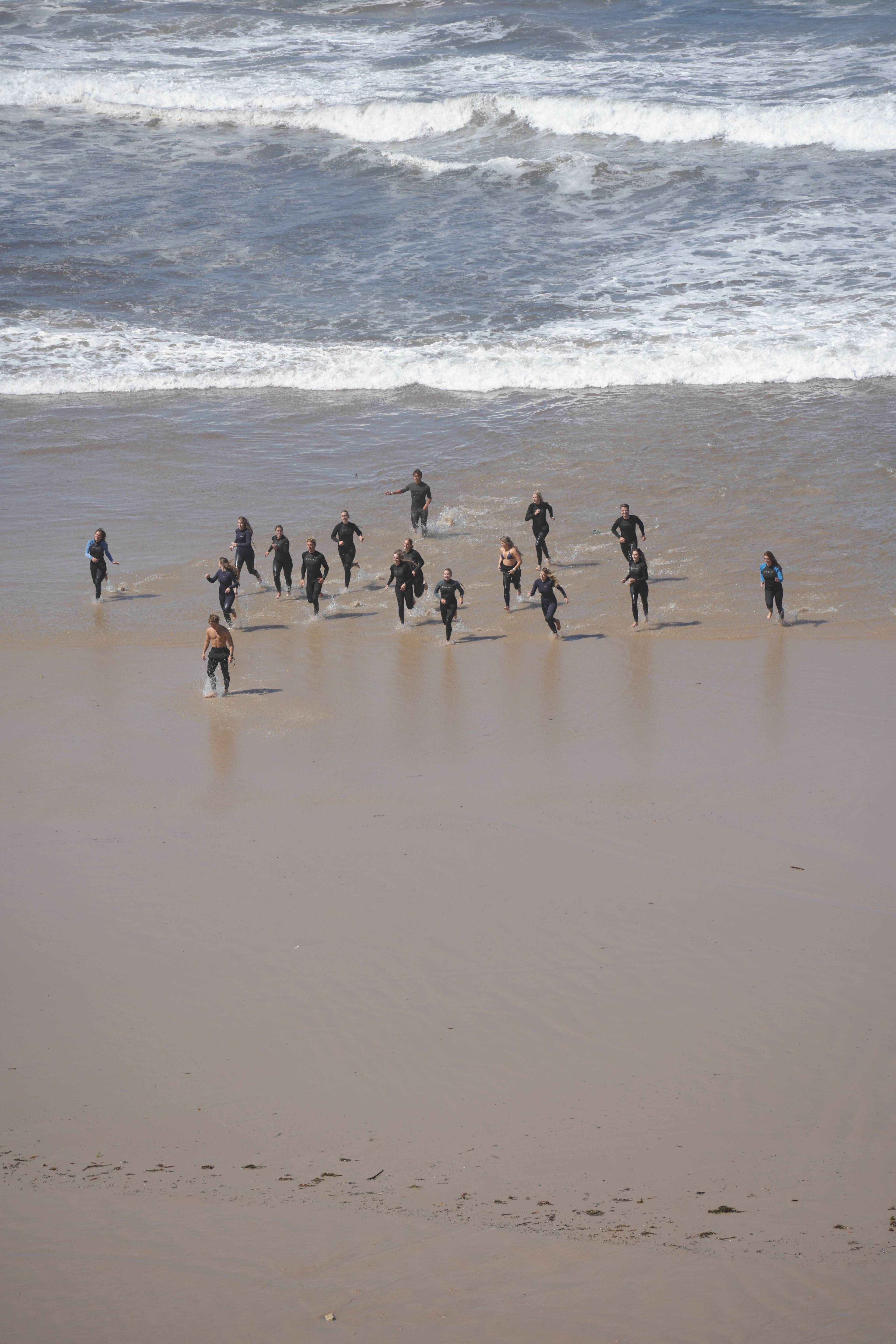 Wetsuits running into the foam together for the first set