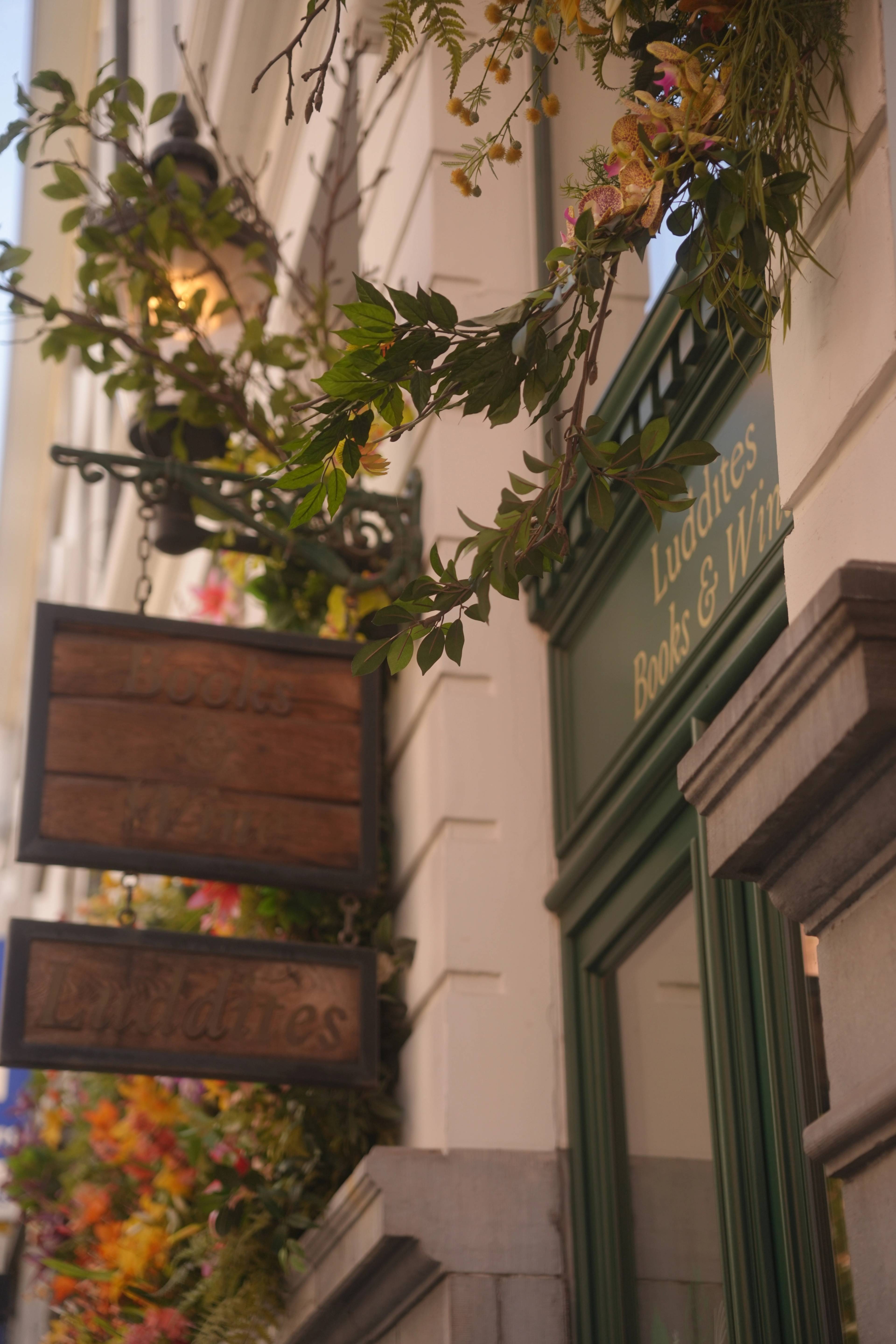 Ivy and a lantern wreathed around the carved Luddites sign