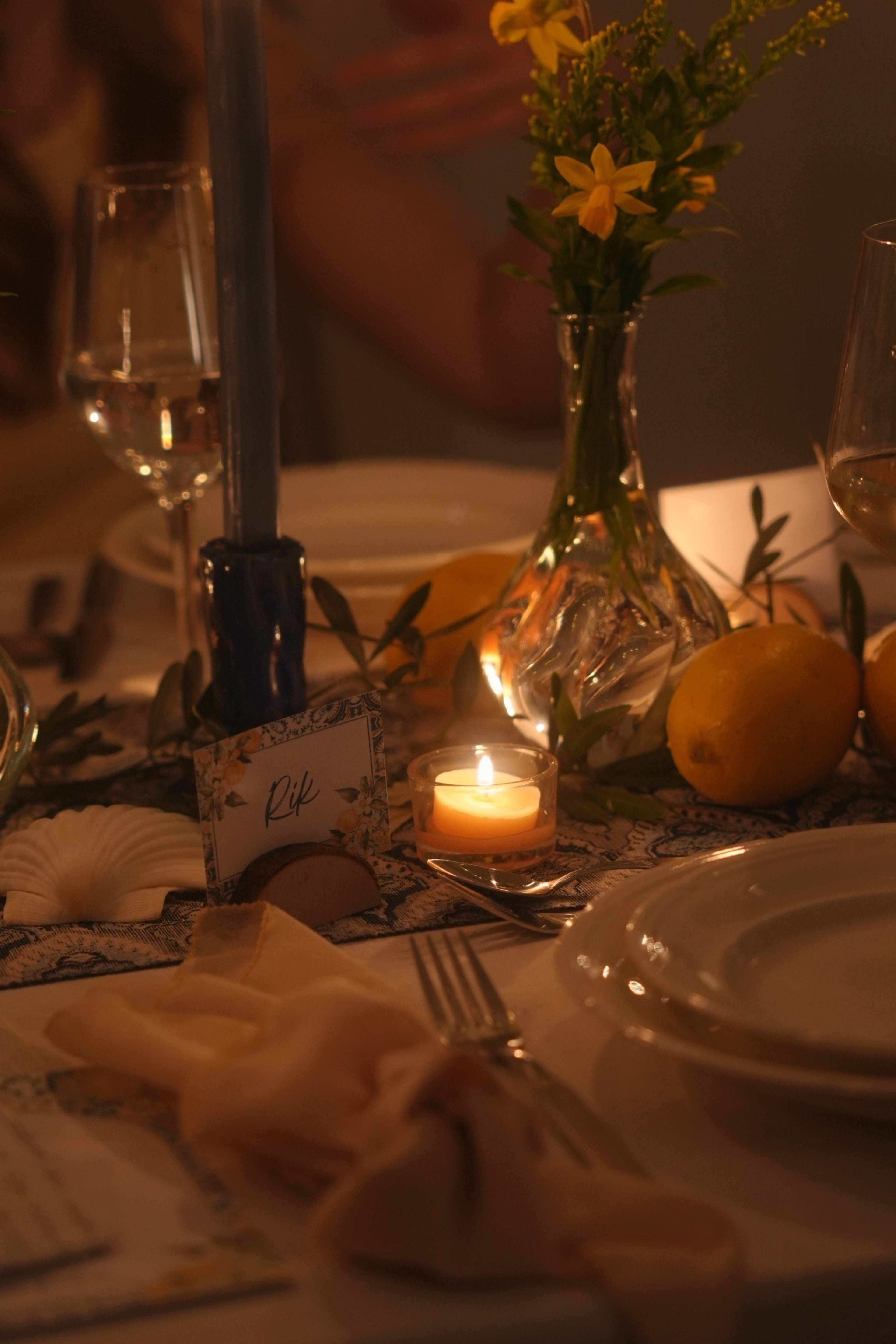 Place setting with Rik's name card, candle and lemons