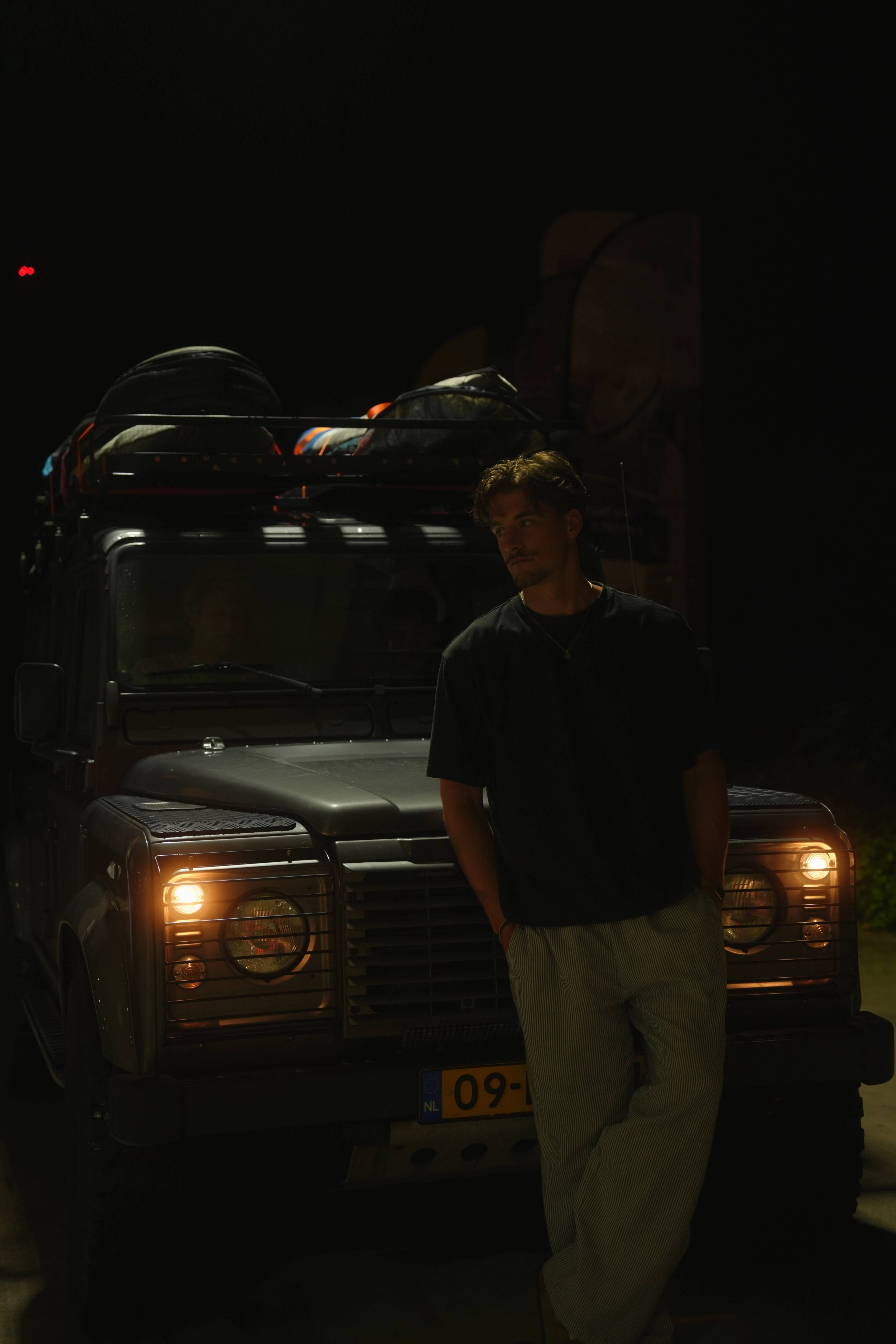 Last night by the Landrover, headlights on, gear still strapped overhead