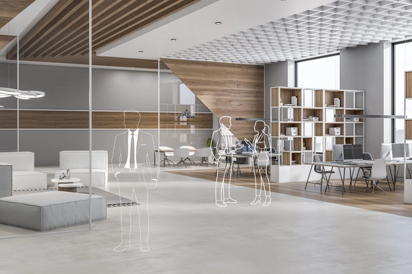 Espace de travail contigu à un espace détente traversés par des personnes.