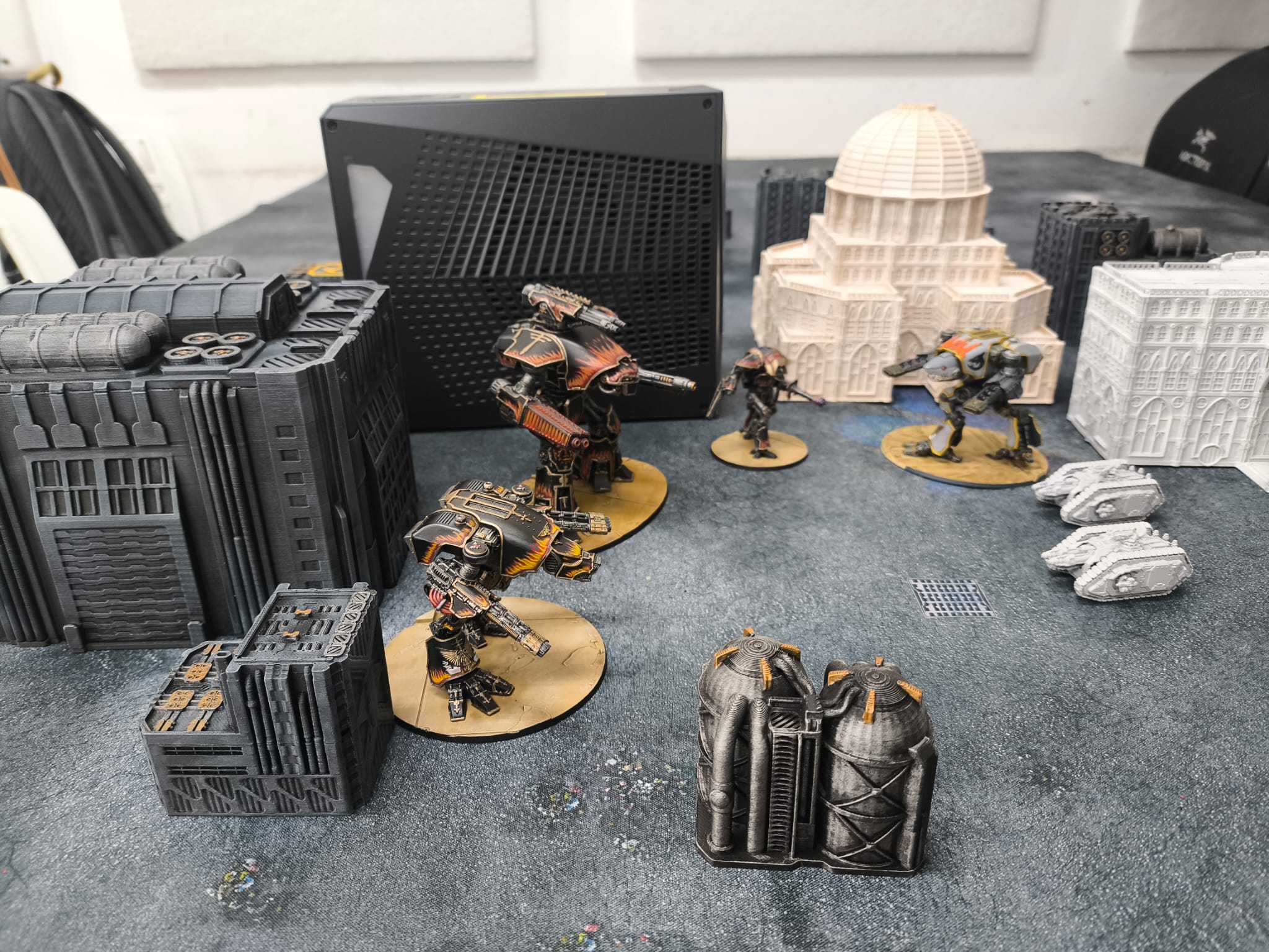 Image of a tabletop wargame with robots and a water-cooling dock in the background