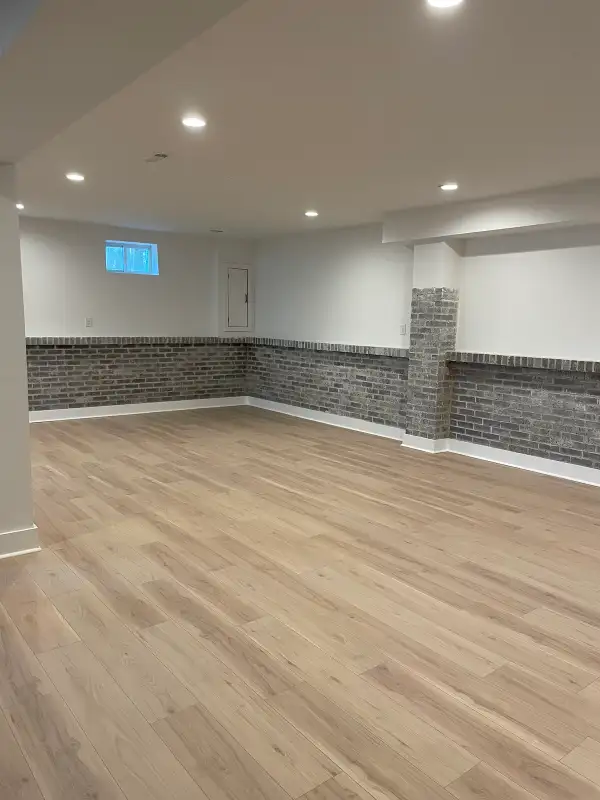 Sicklerville, NJ Luxury Basement Finishing & Full Lower-Level Renovation — Exposed Brick Wainscoting, Wide-Plank LVP Flooring, Recessed LED Lighting & Finished Hallway Suite