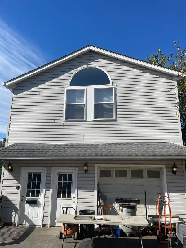 Brookhaven, PA Full Exterior Siding Replacement — New Vinyl Siding, Barricade & Tyvek House Wrap Weather Barrier, White Trim Package & Arched Window Surround on Two-Story Garage Structure