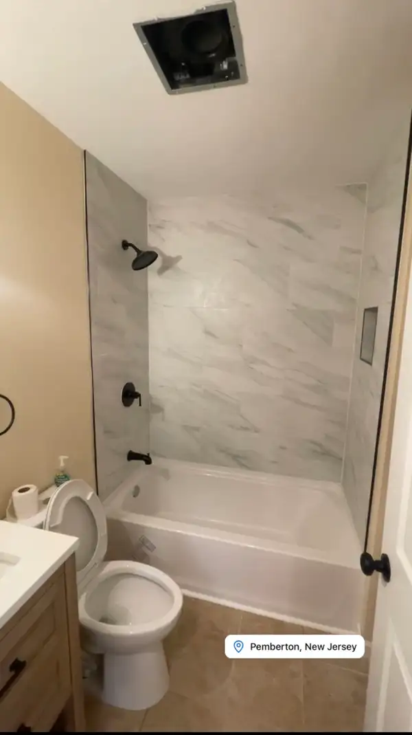 Pemberton, NJ Full Bathroom Renovation — Large-Format Calacatta Marble-Look Tile Tub Surround, Built-In Shower Niche, Matte Black Fixtures, Natural Wood Vanity & Round Matte Black Mirror