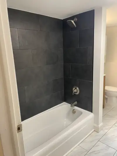 Shamong, NJ Luxury Bathroom Tub & Shower Renovation — Large-Format Charcoal Slate-Look Porcelain Tile Surround, Custom Black & Gold Geometric Mosaic Niche Accent, Marble-Look Floor Tile & Brushed Nickel Fixture Package