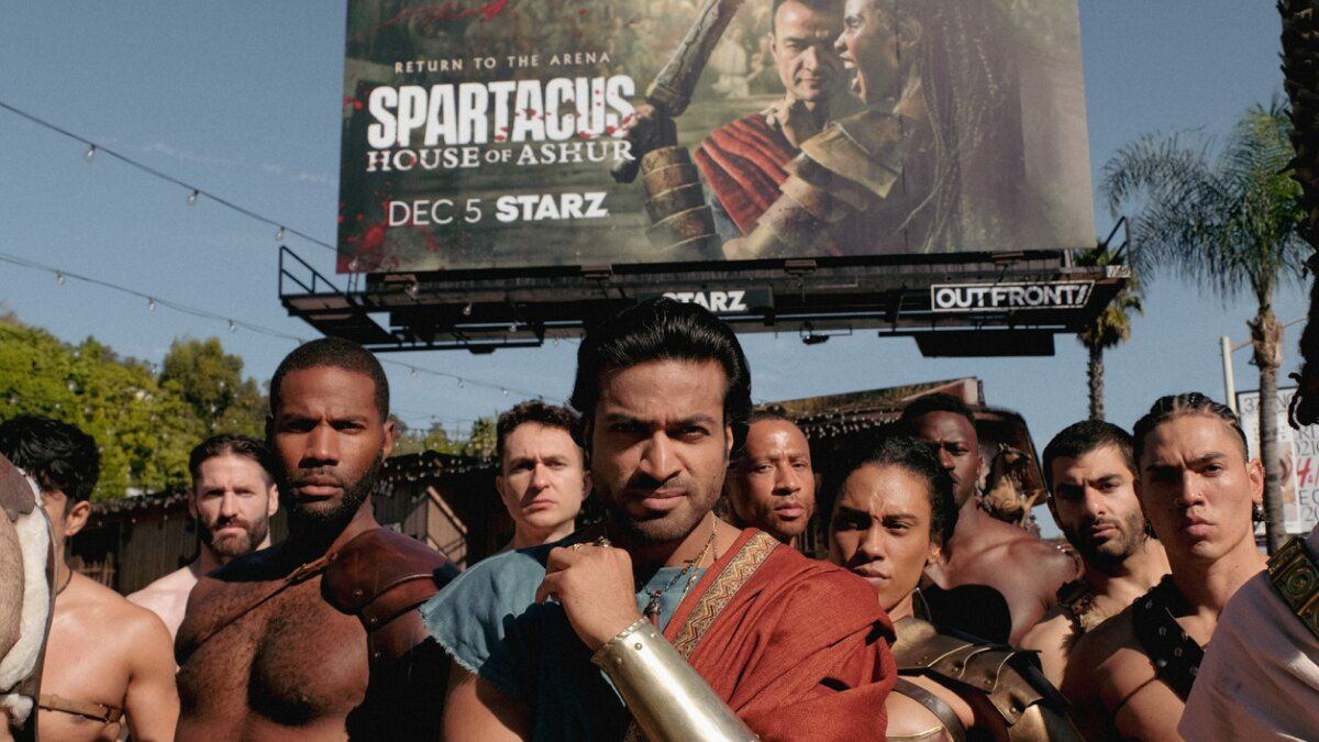 Spartacus billboard and gladiators posing in front