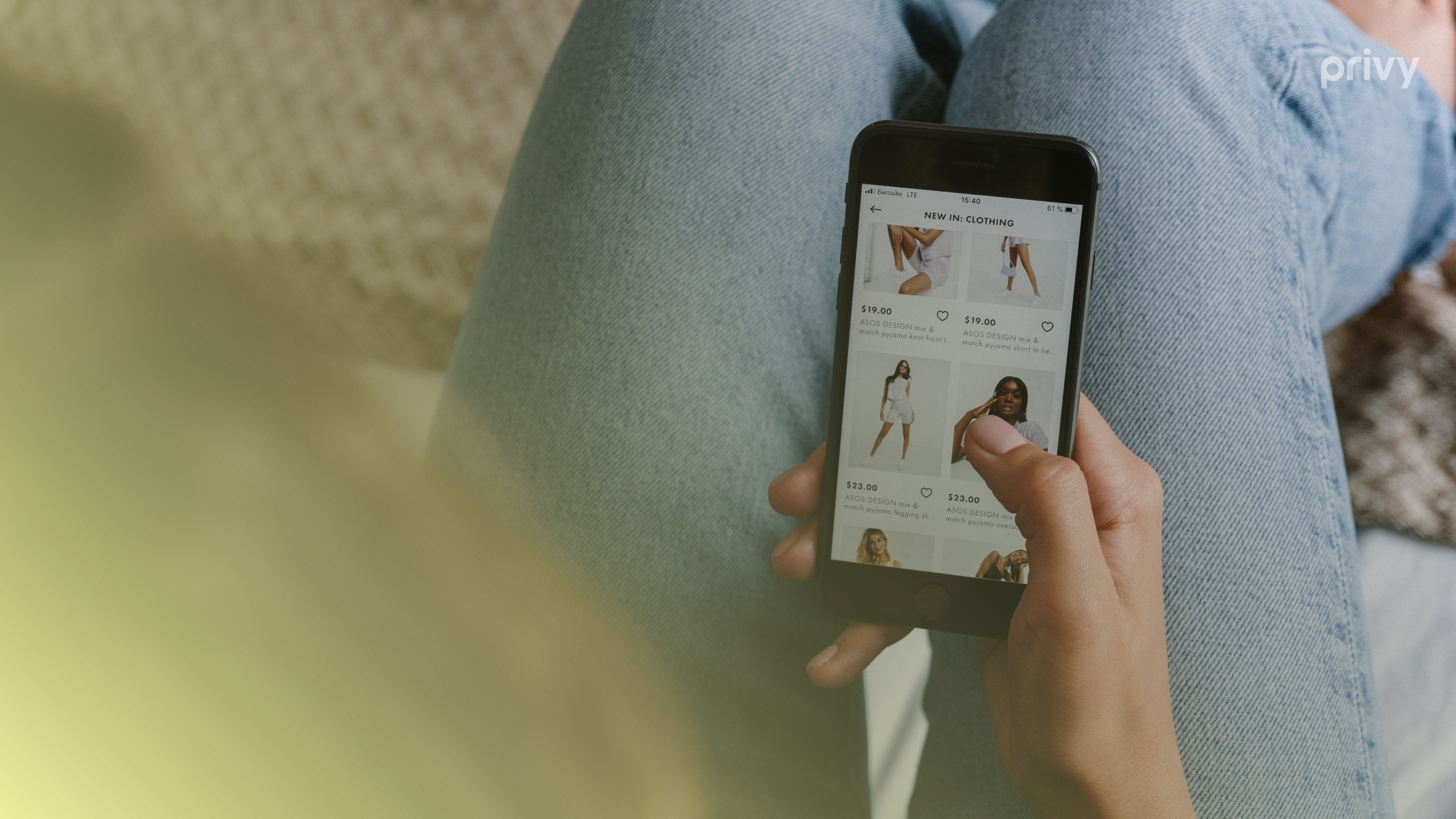 Person holding a mobile device shopping online