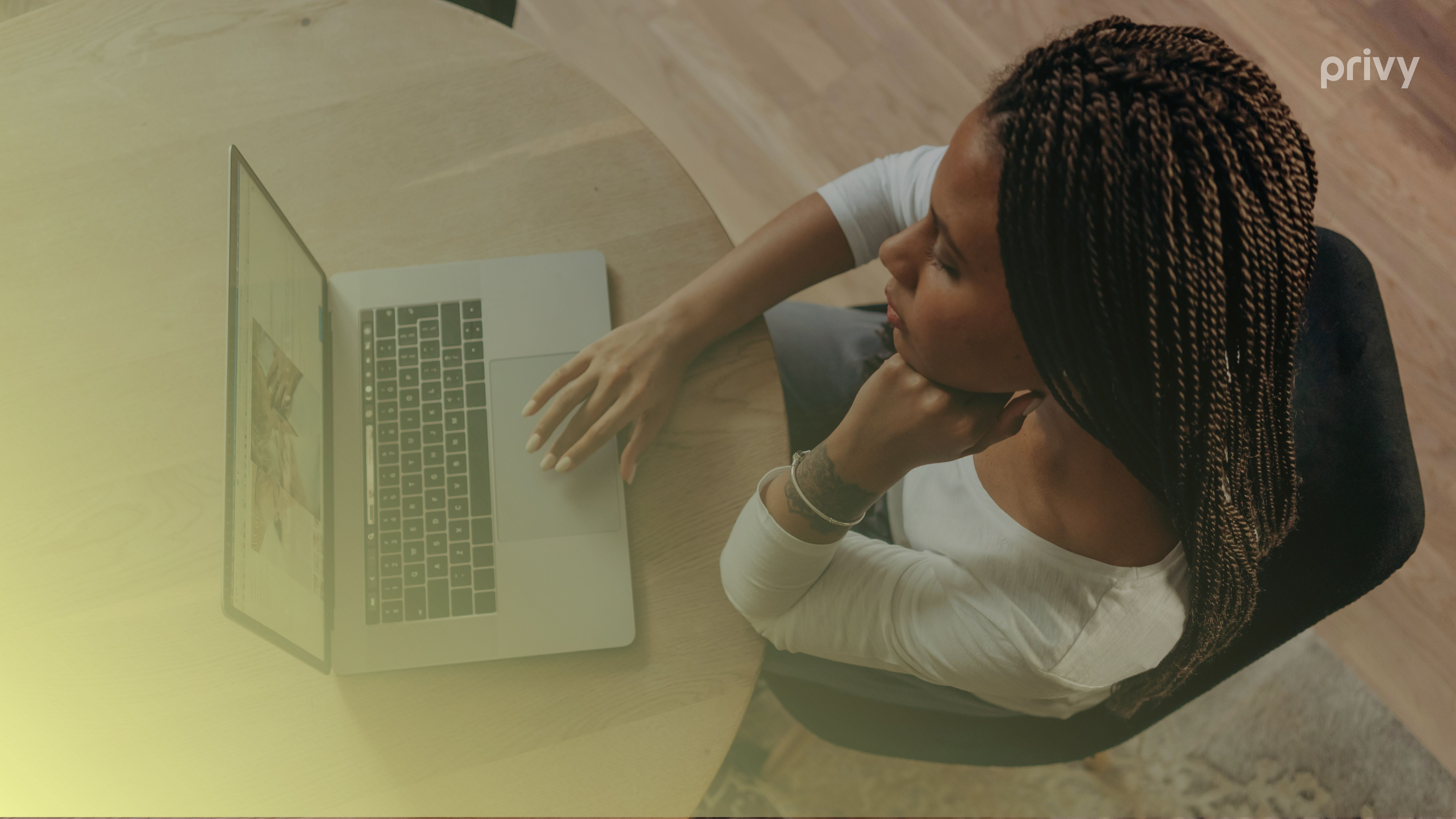 A woman staring at a laptop planning for Black Friday sales
