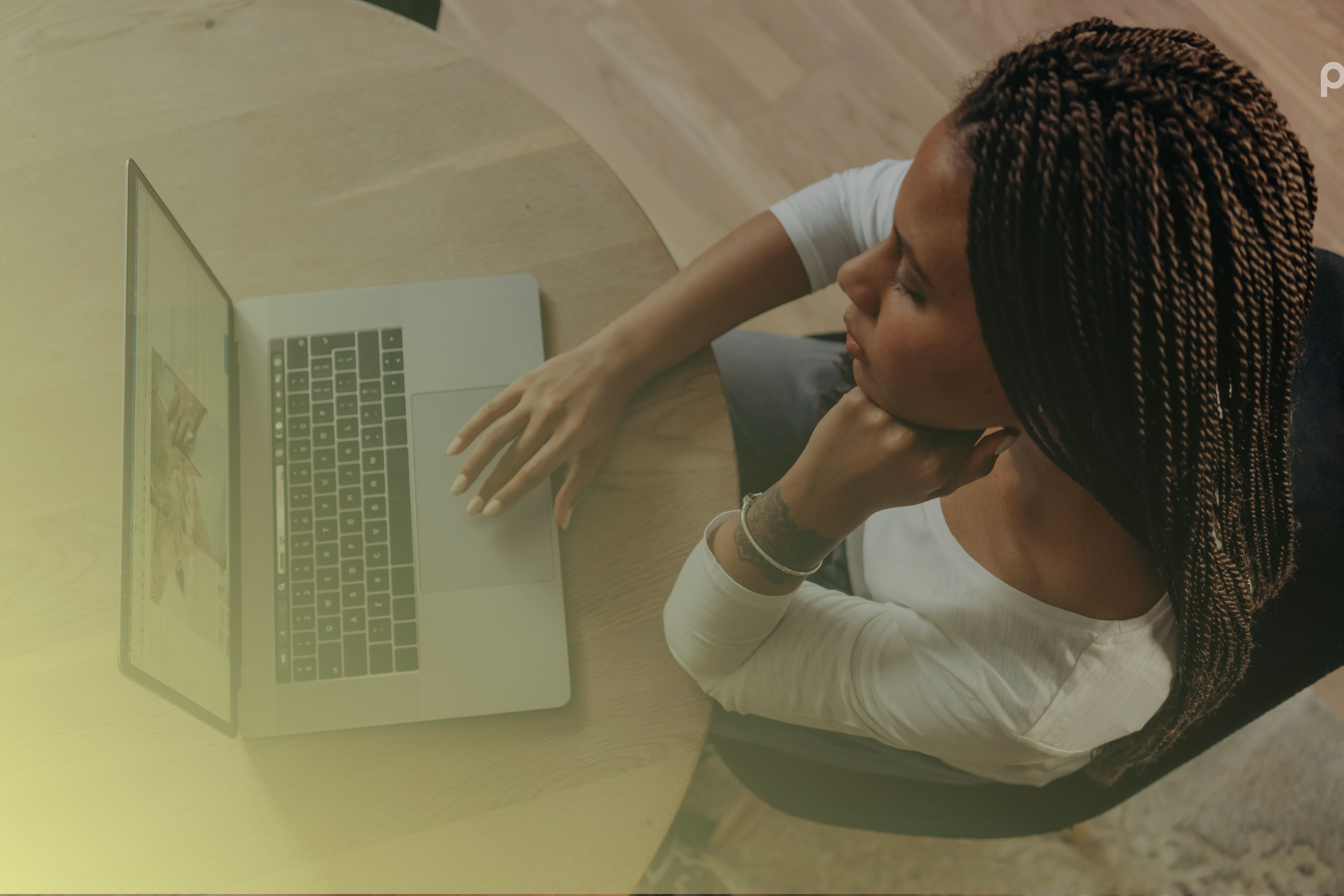 A woman staring at a laptop planning for Black Friday sales