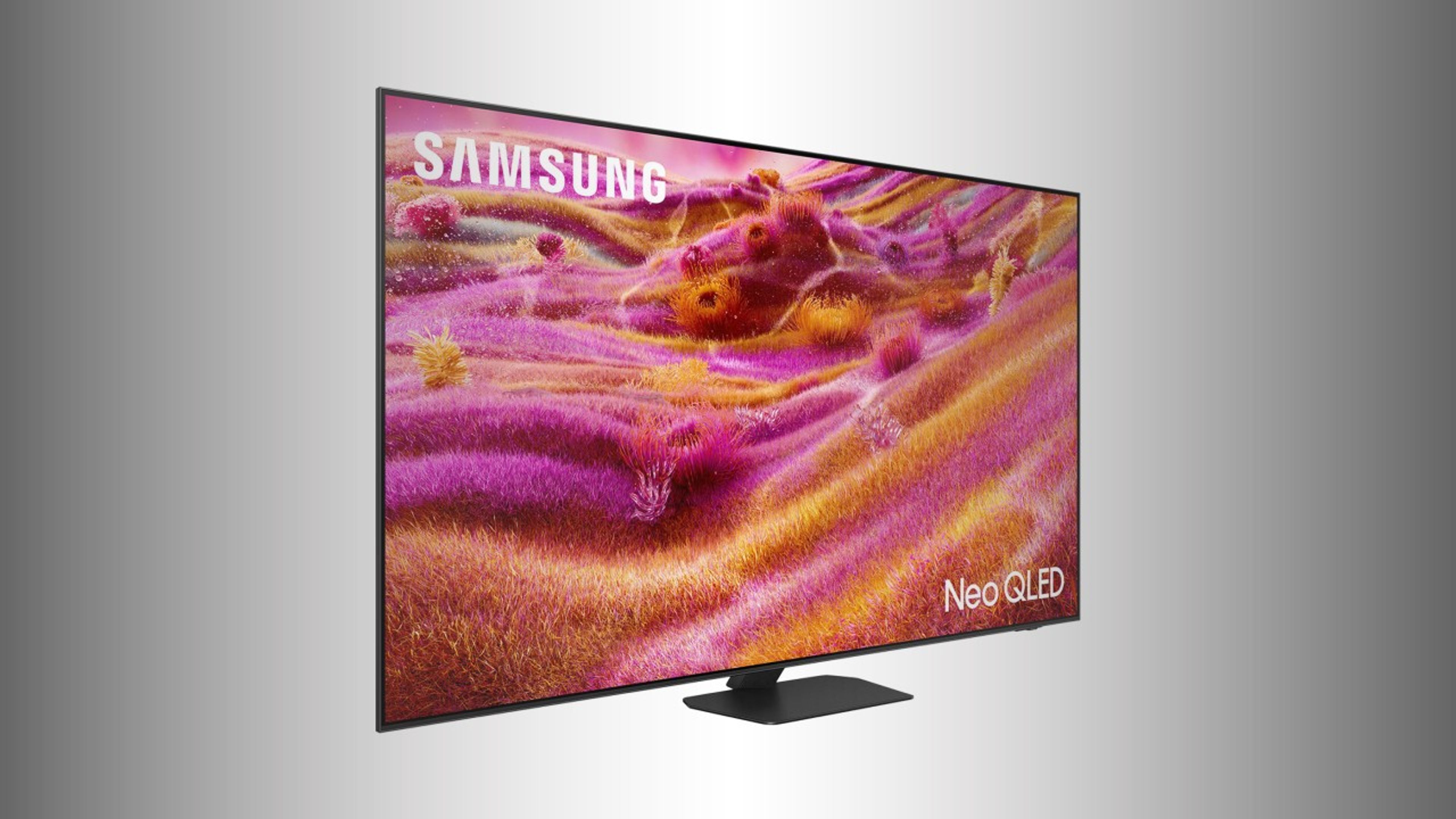 The Samsung QN90F TV displayed in a modern living room, showcasing vivid colors and deep contrast on a sleek, ultra-thin Mini-LED screen.