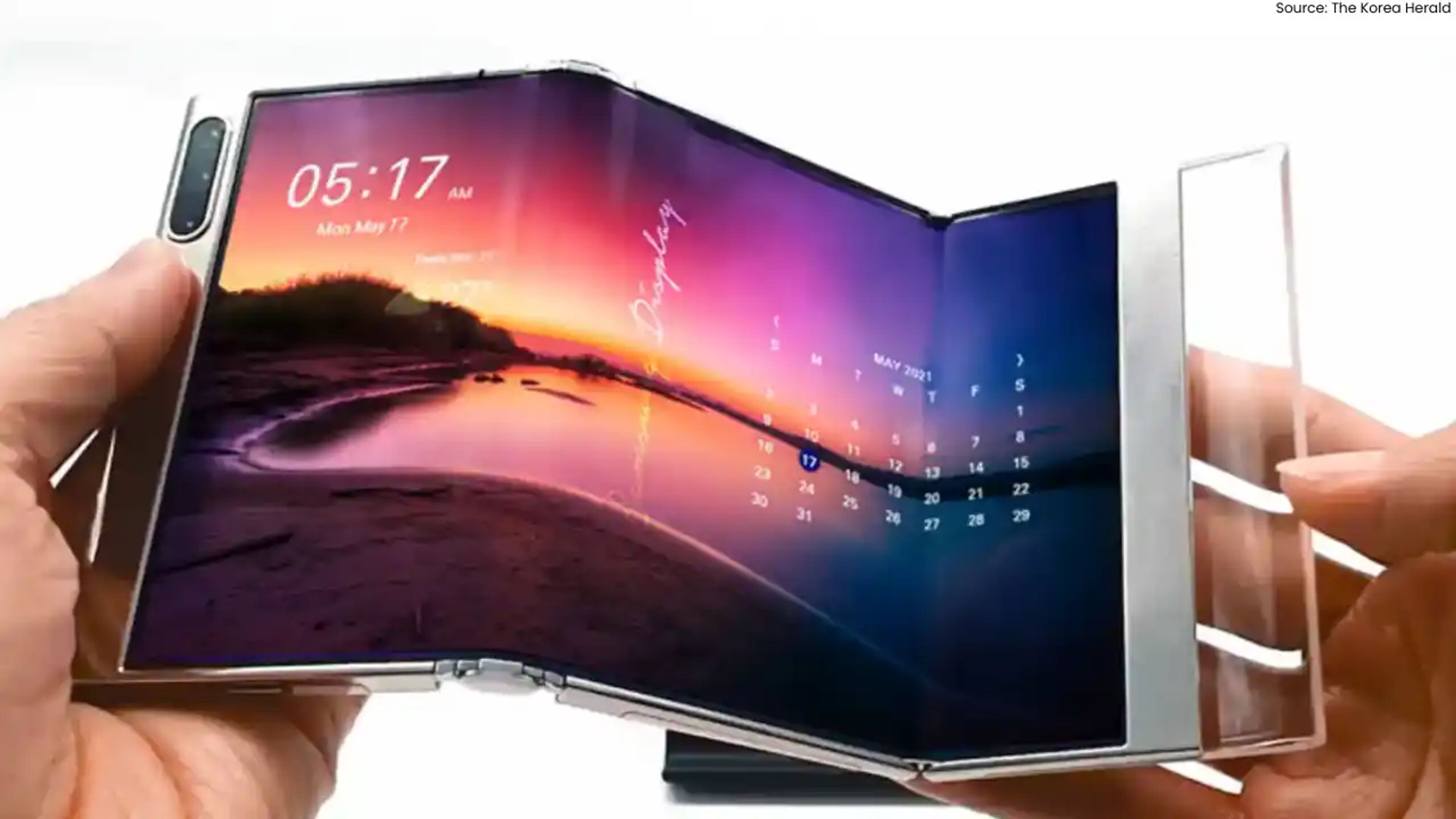Samsung’s concept tri-fold phone in mid-unfold, showcasing multiple screen panels displaying apps, media, and productivity tools.
