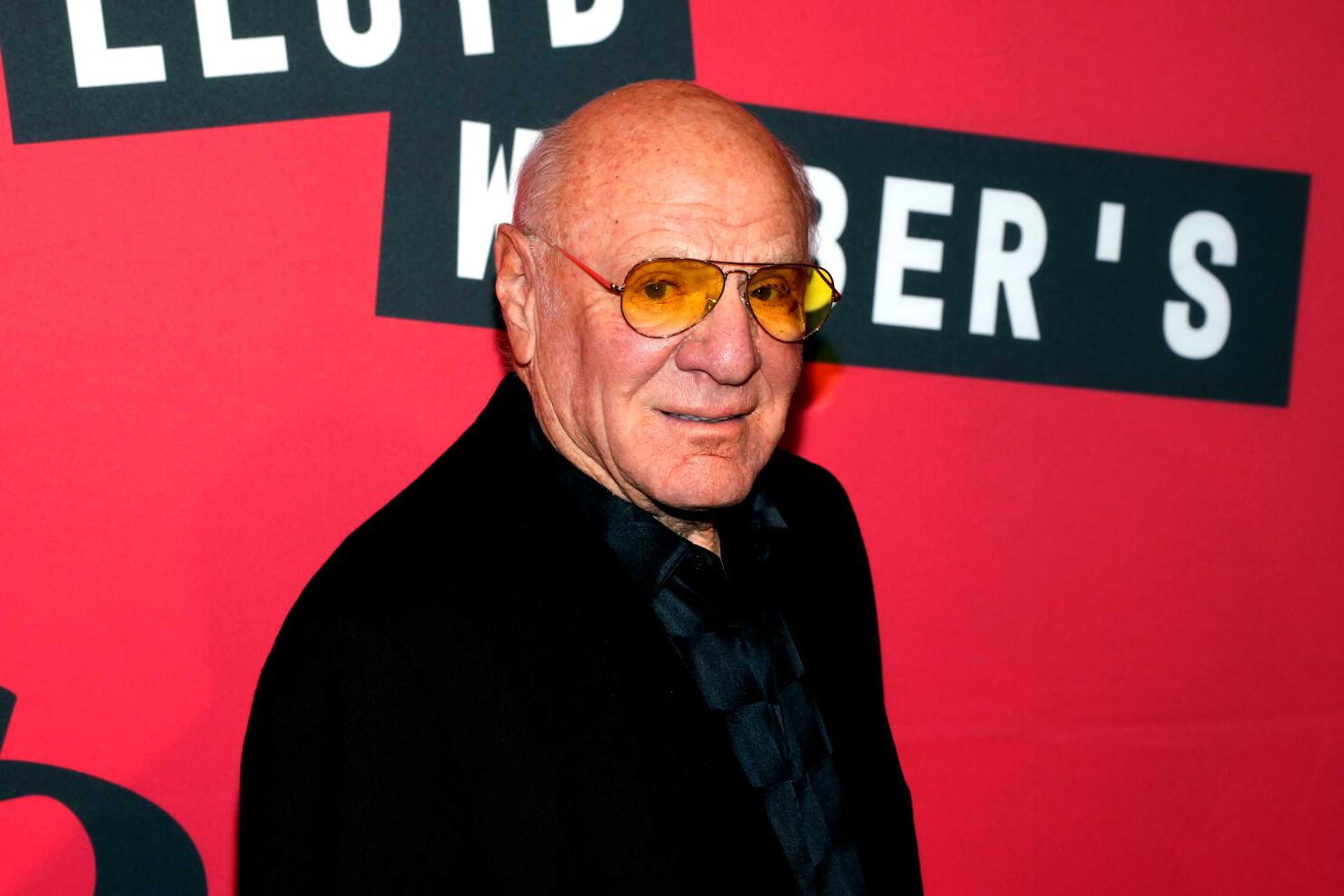 Portrait of Barry Diller set against a split background of old Hollywood film reels and modern digital media icons, symbolizing his influence across eras.