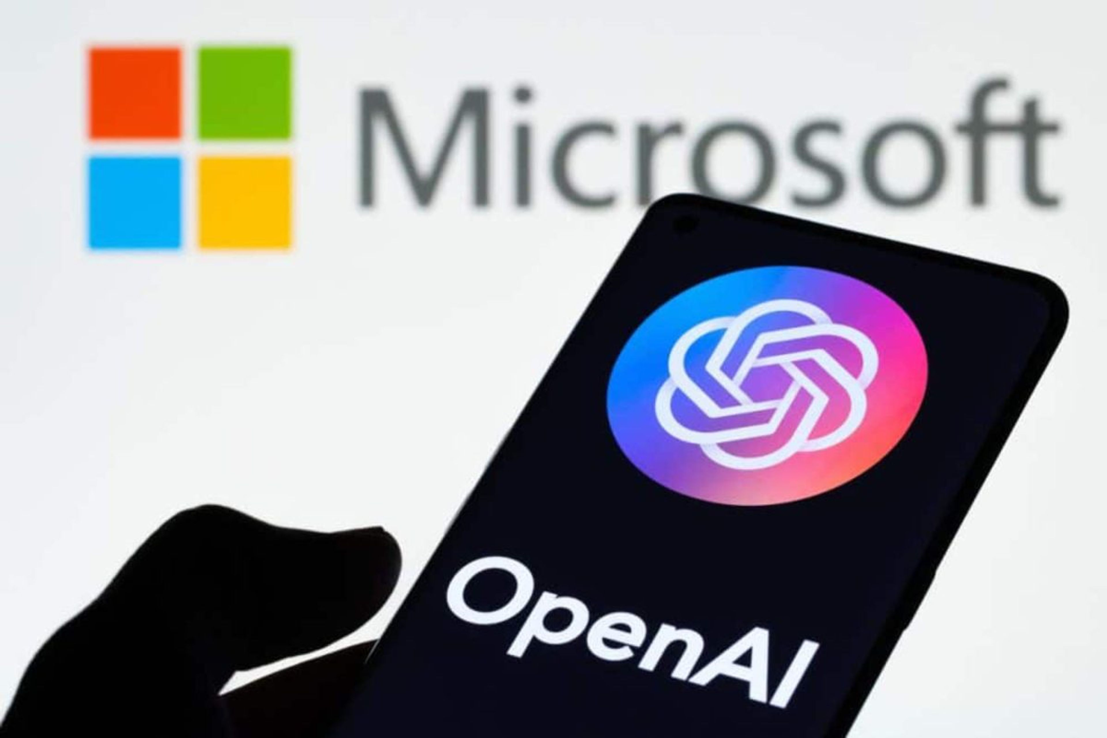 Logos of OpenAI and Microsoft intertwined over a digital circuit board, symbolizing their complex blend of partnership and competition in AI development.