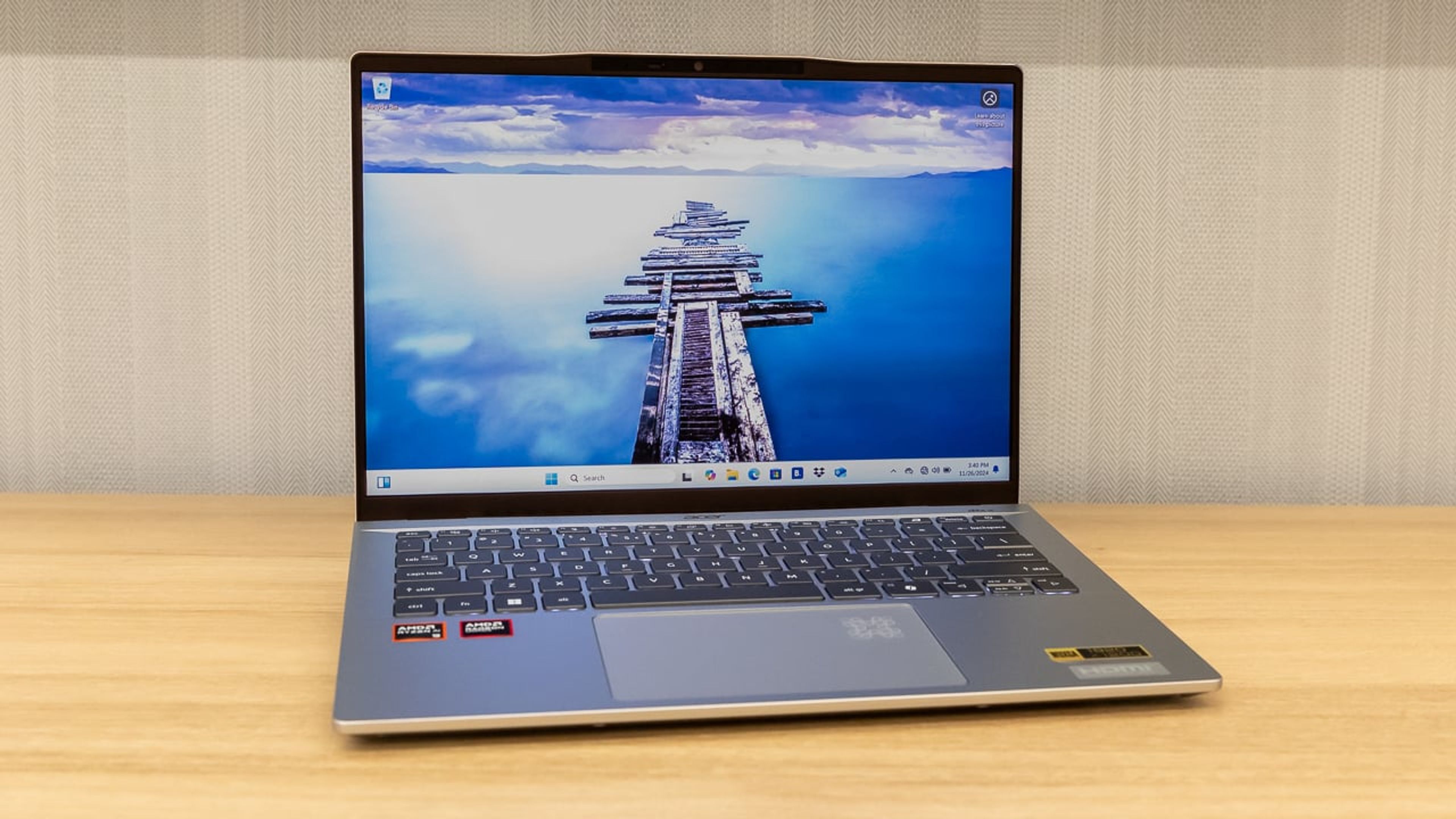 The Acer Swift 14 AI laptop open on a desk, displaying a vibrant screen and a slim, modern chassis—emphasizing both performance and portability.
