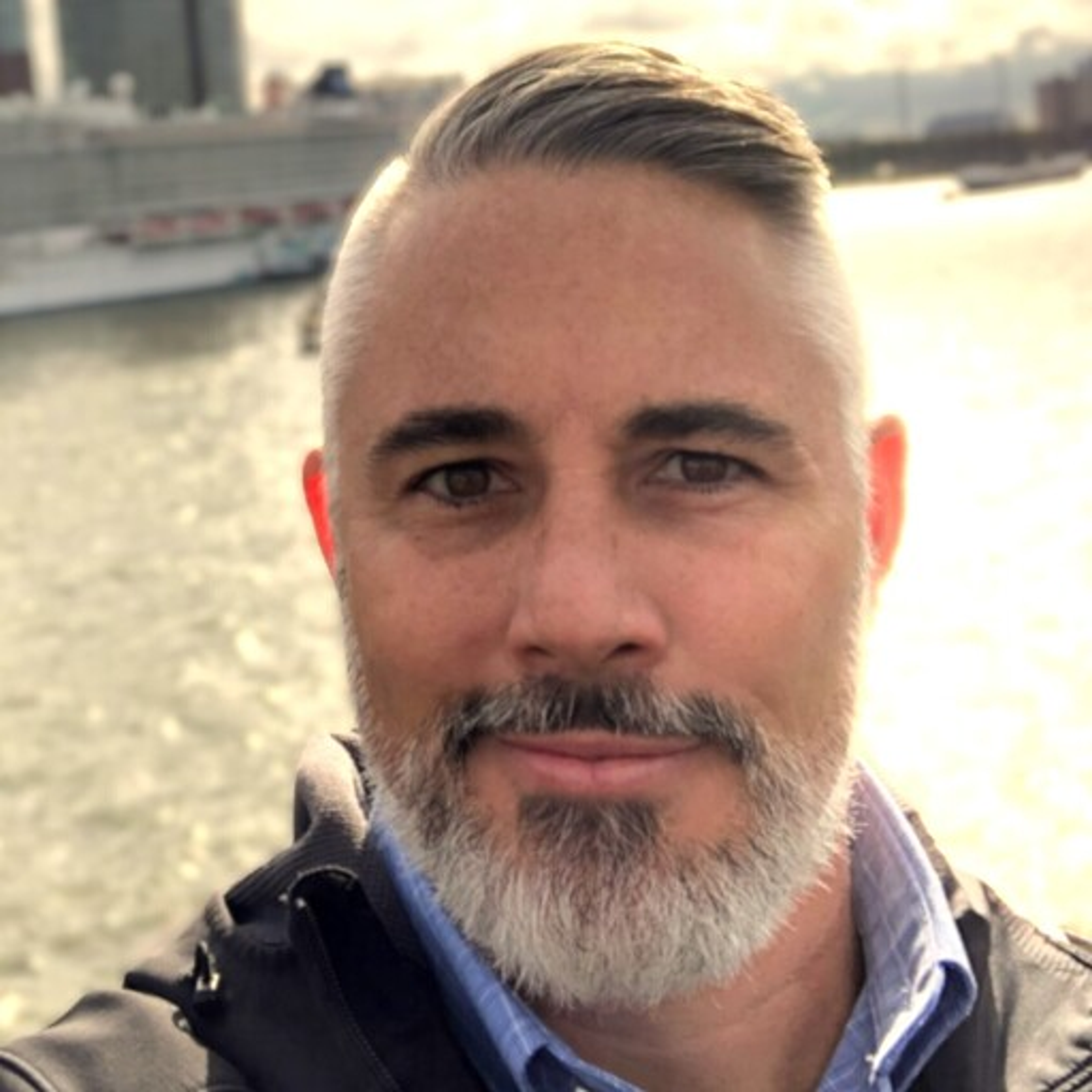 A head shot of Chad Ballentine standing in front of a river.