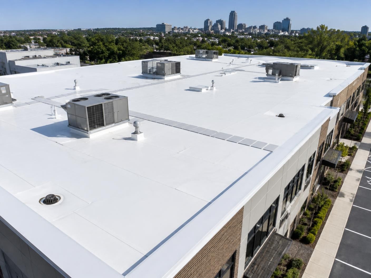 Completed white TPO membrane roof on a Raleigh commercial building