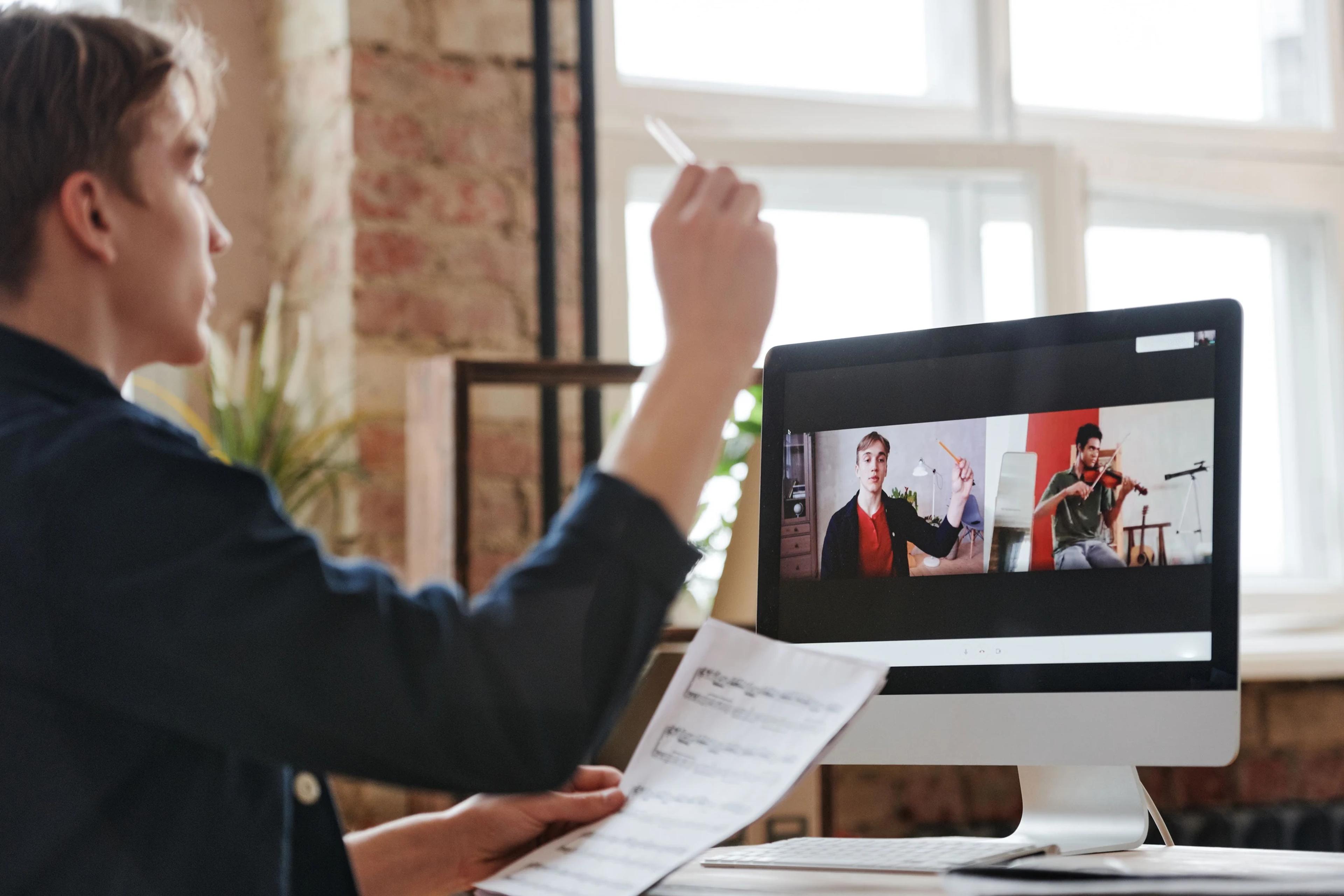 Music teacher conducting a live online lesson with students on a video call