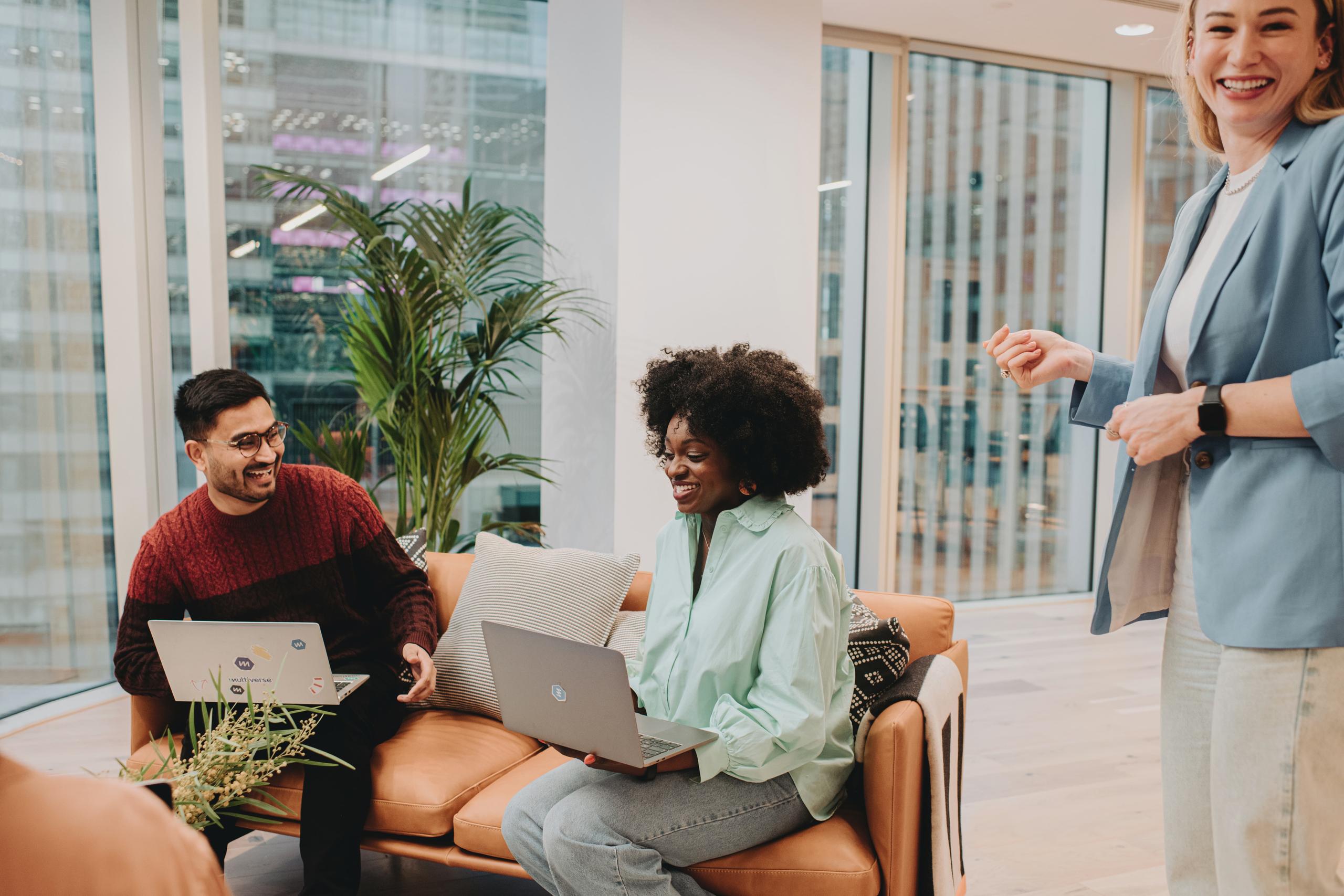 A man and two woman having a laugh in the office