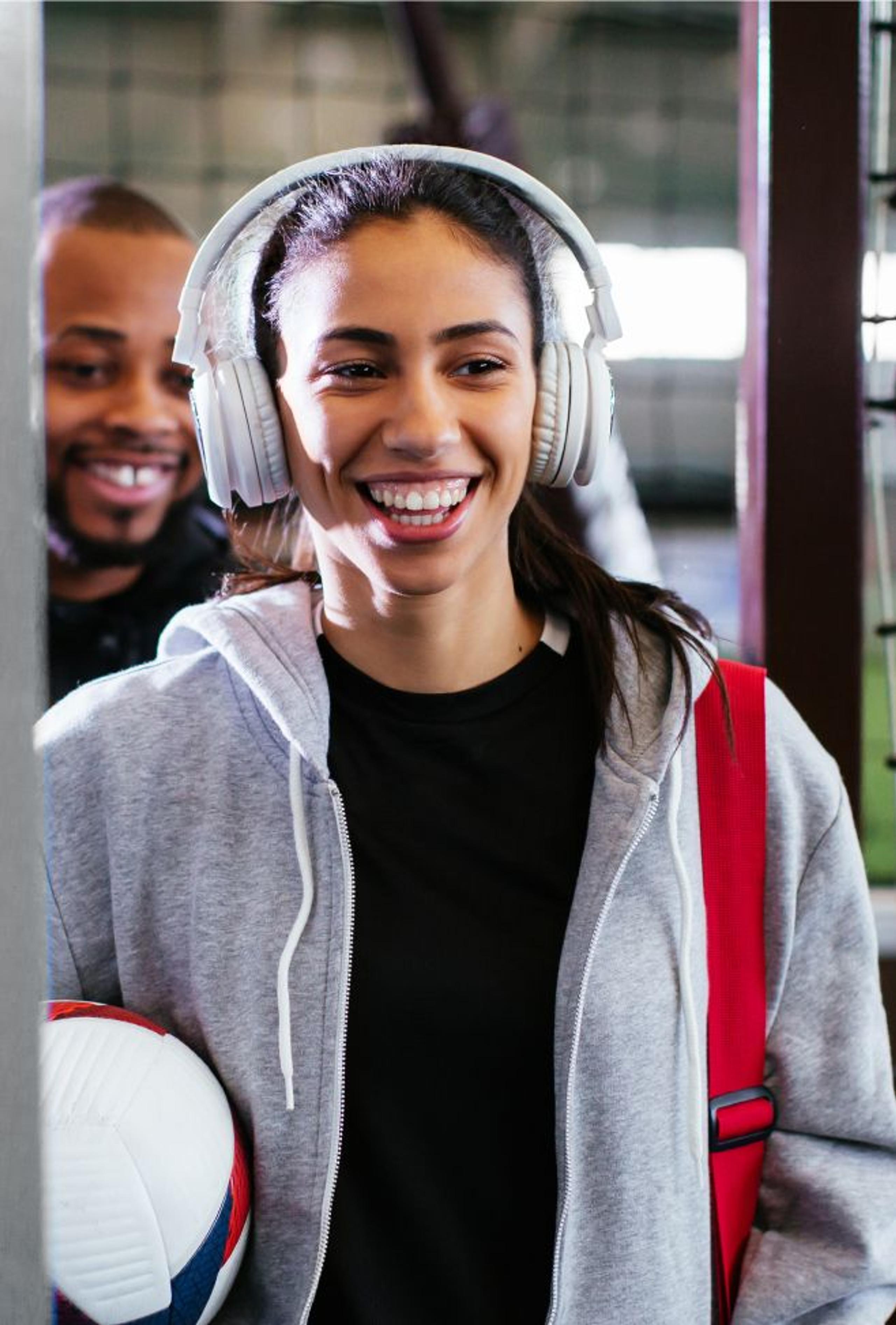 A woman smiling listing to music