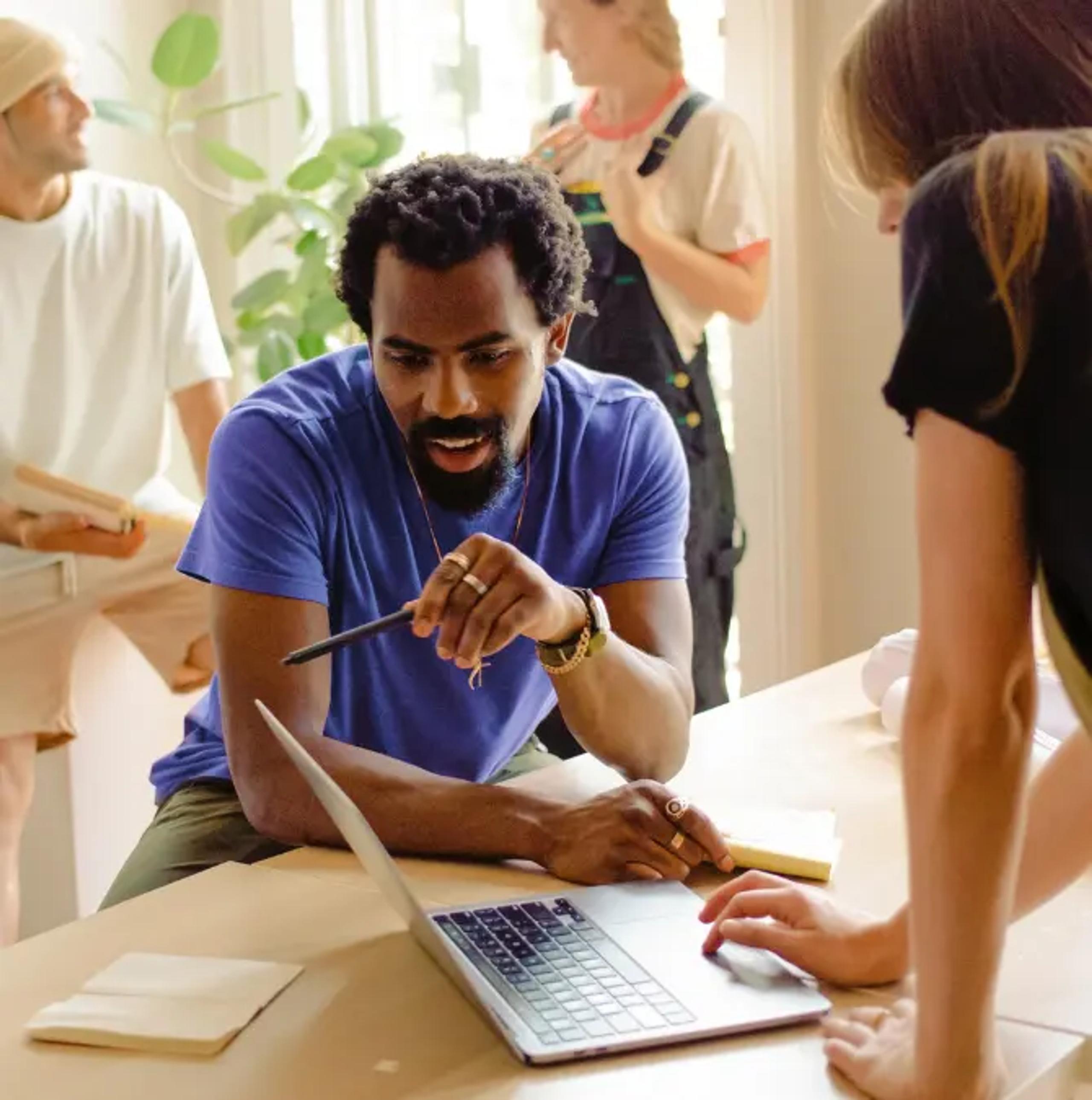 Two people working at a laptop