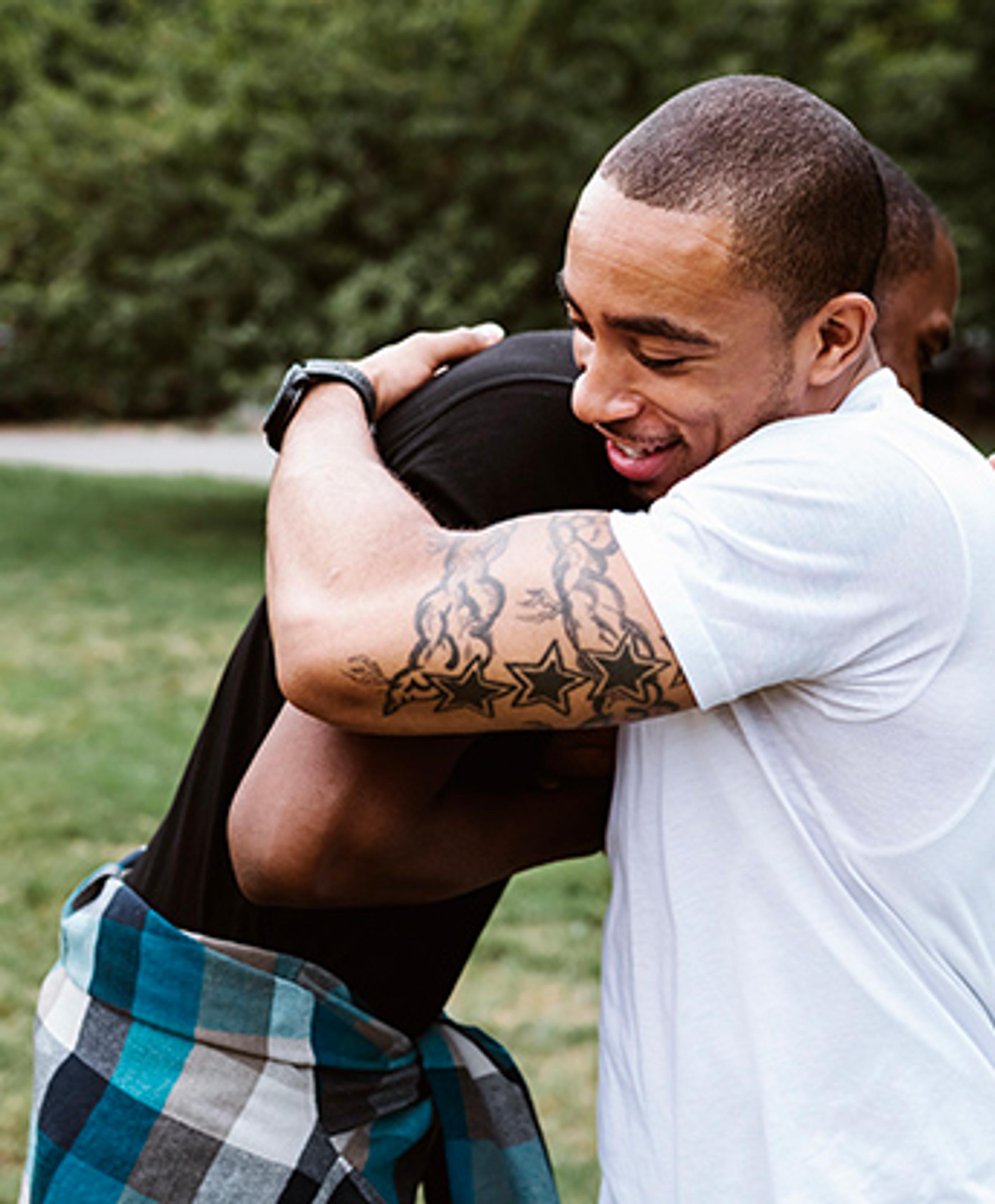 Two men hugging