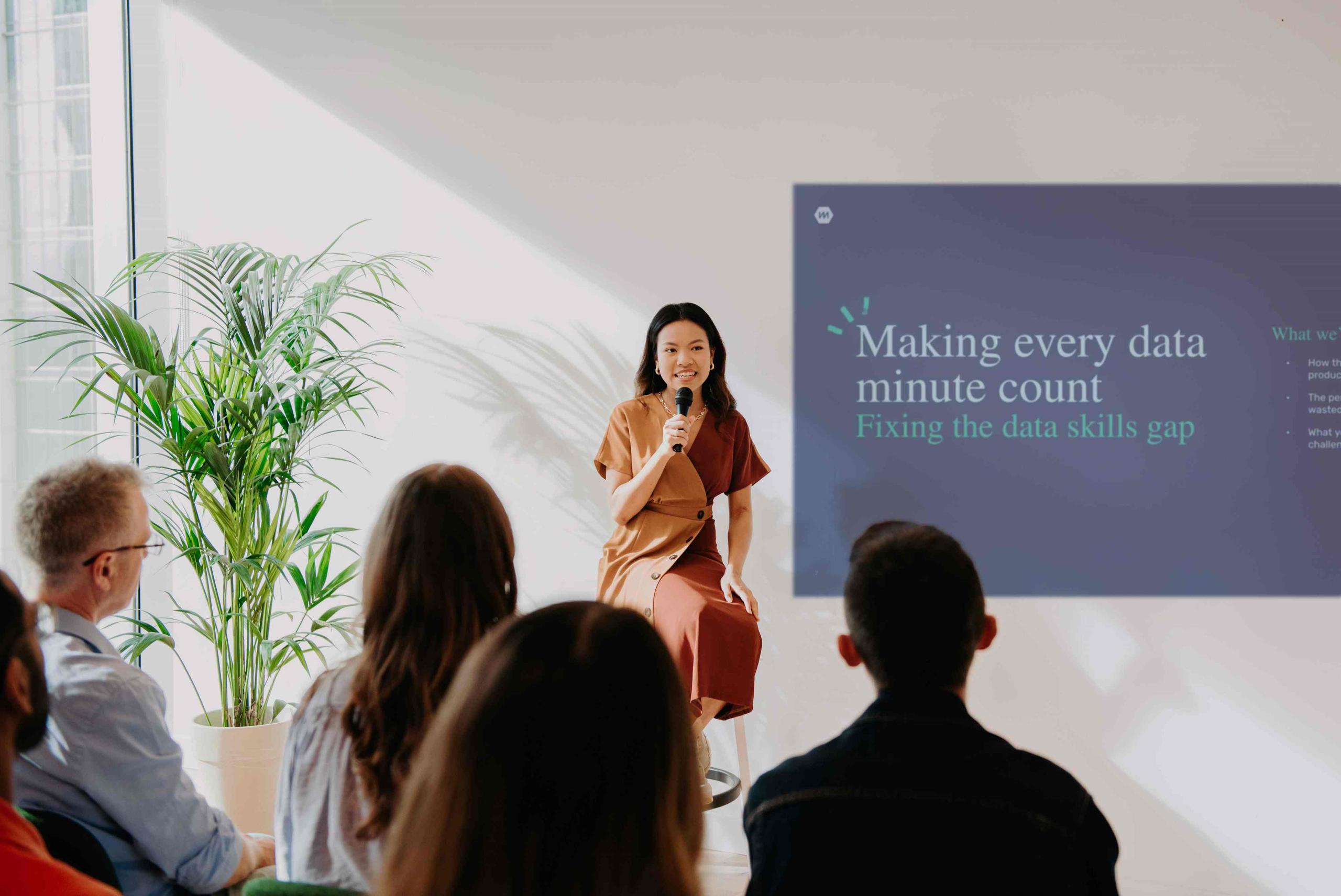 A woman presenting to a crowd