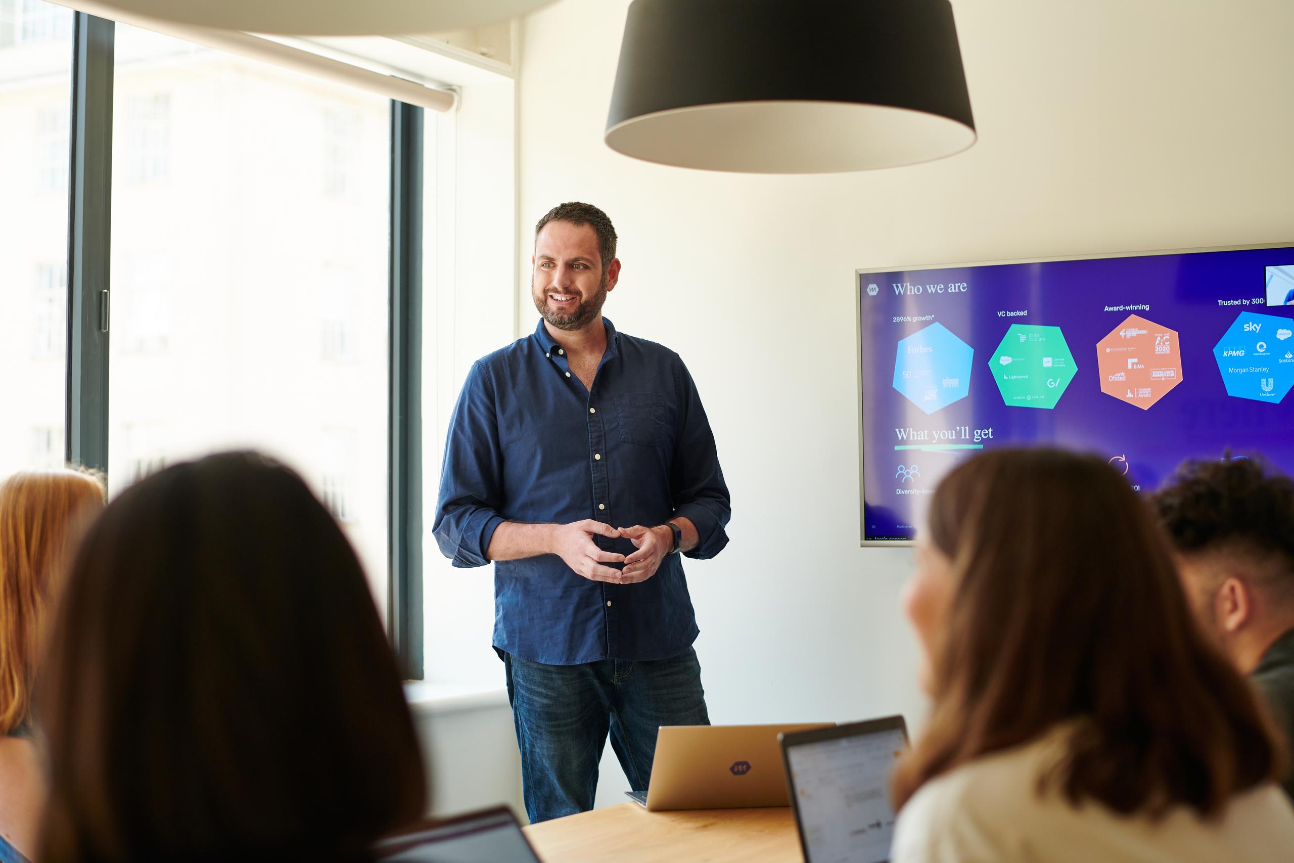 Man presenting to a group of people 