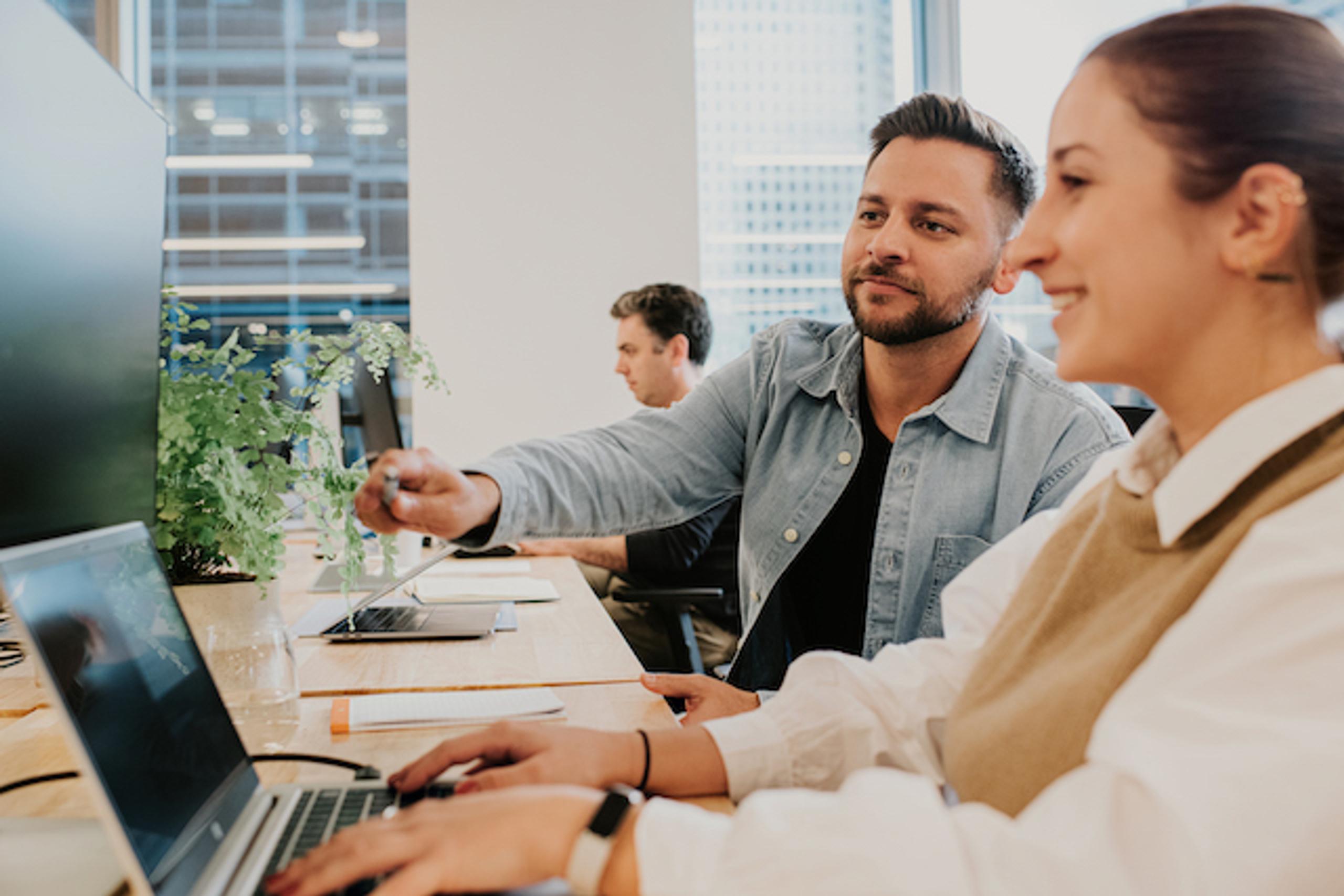 Two colleagues working together at a monitor