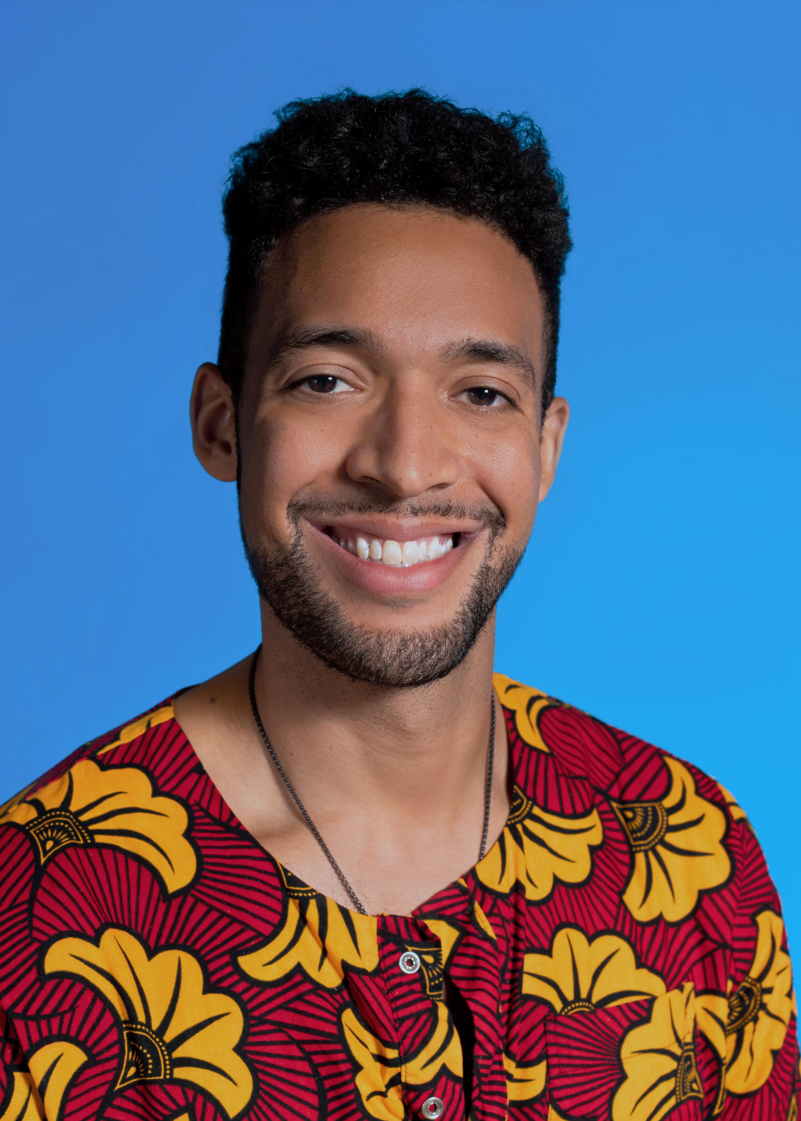 Alec Brownridge headshot on blue background