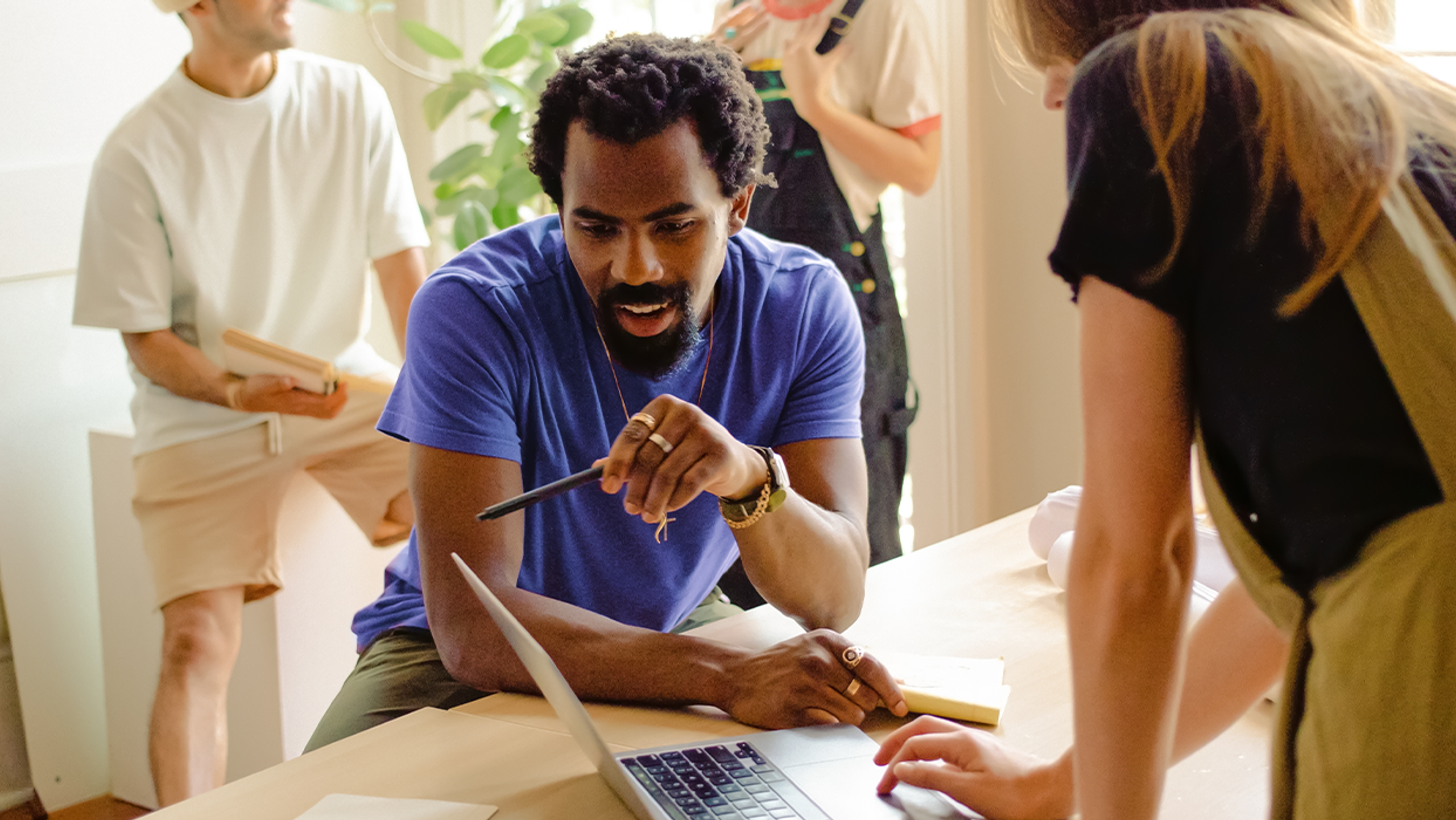 People studying at a desk- AI for business value course