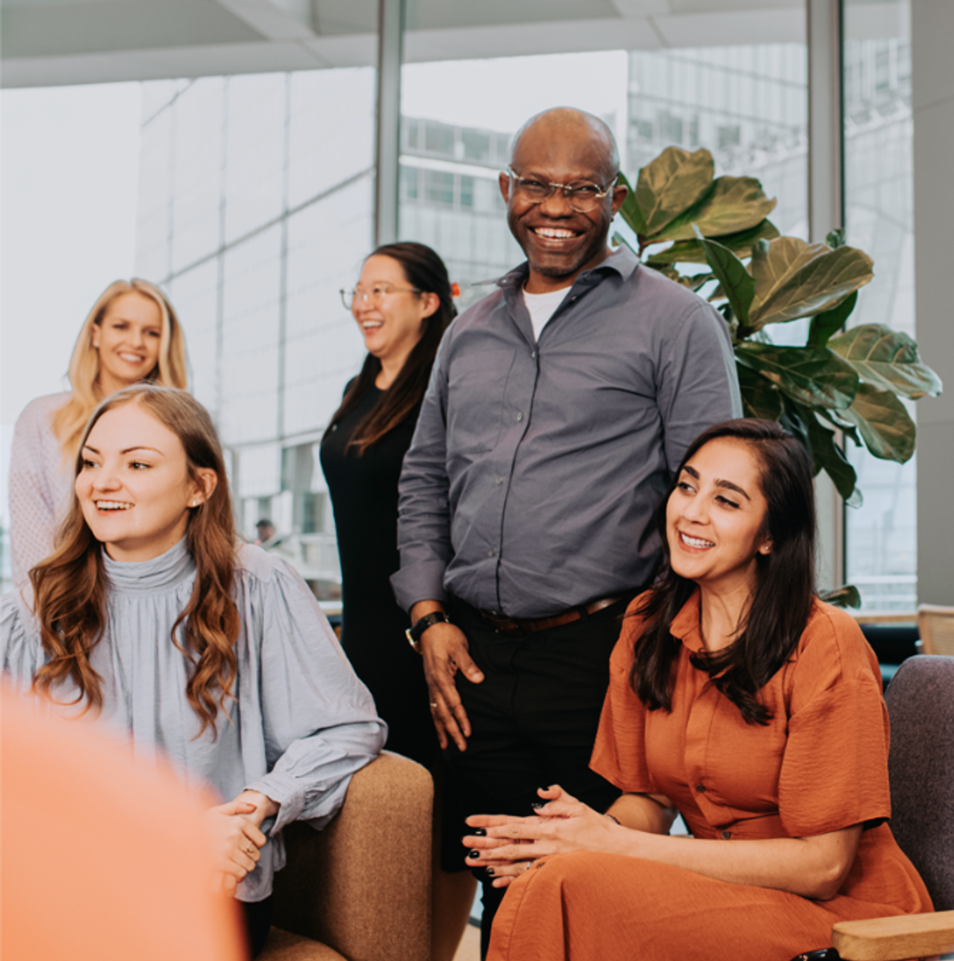 Employees in an informal setting looking happy and chatting