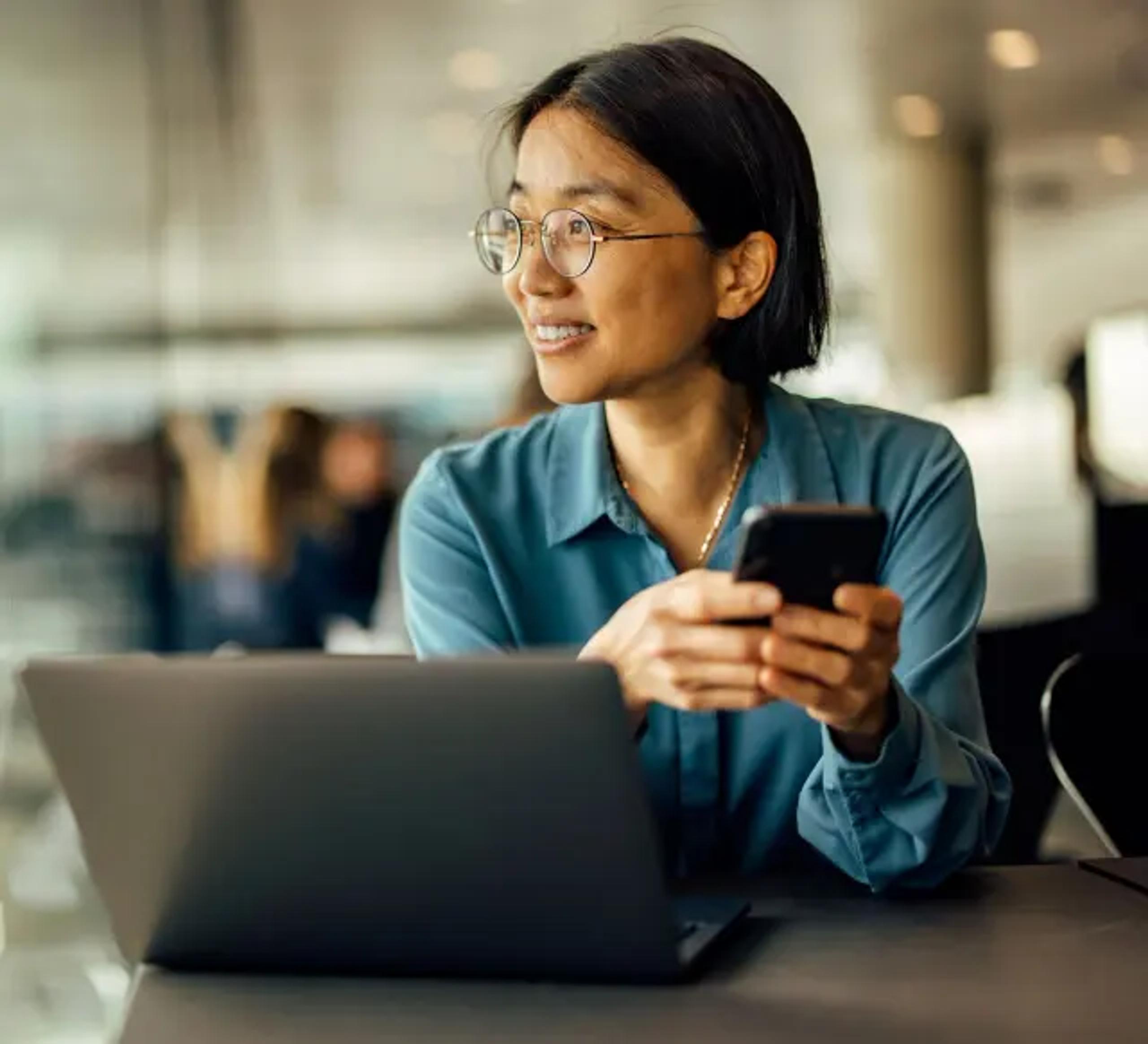 Woman smiling with her phone