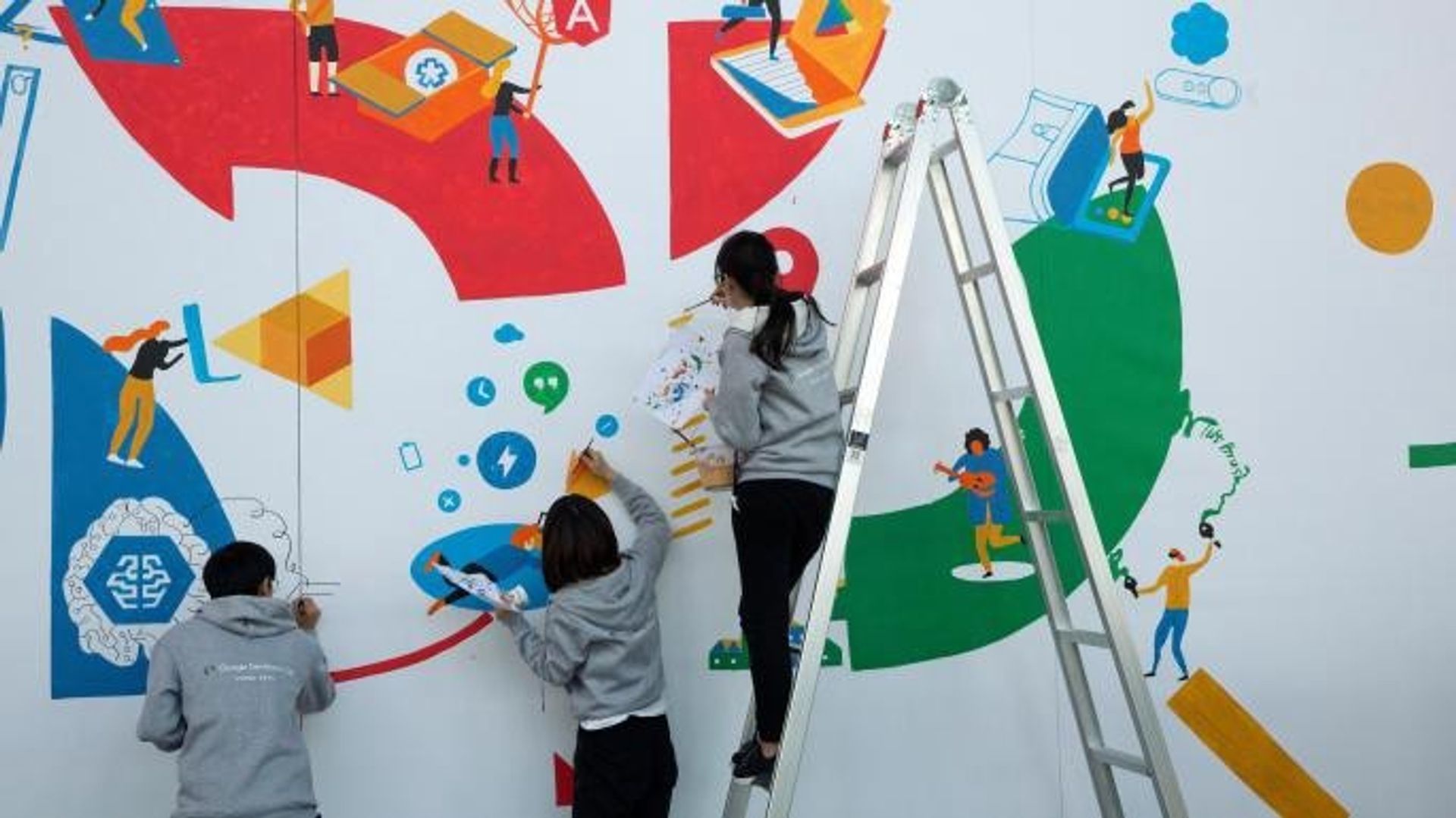 An image of people painting a mural