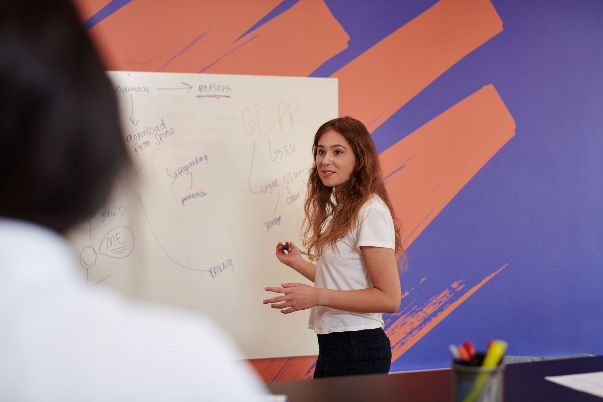An apprentice stands at a whiteboard